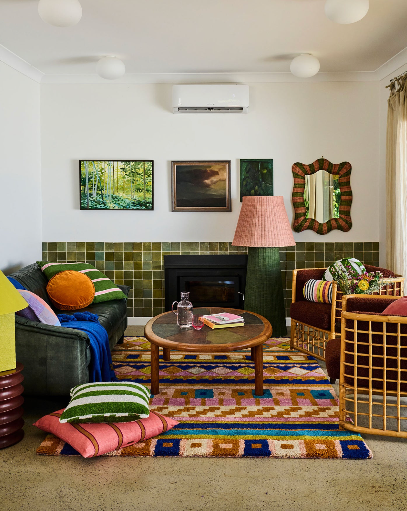Living room with colourful decor, including a rug, furniture, and wall art.