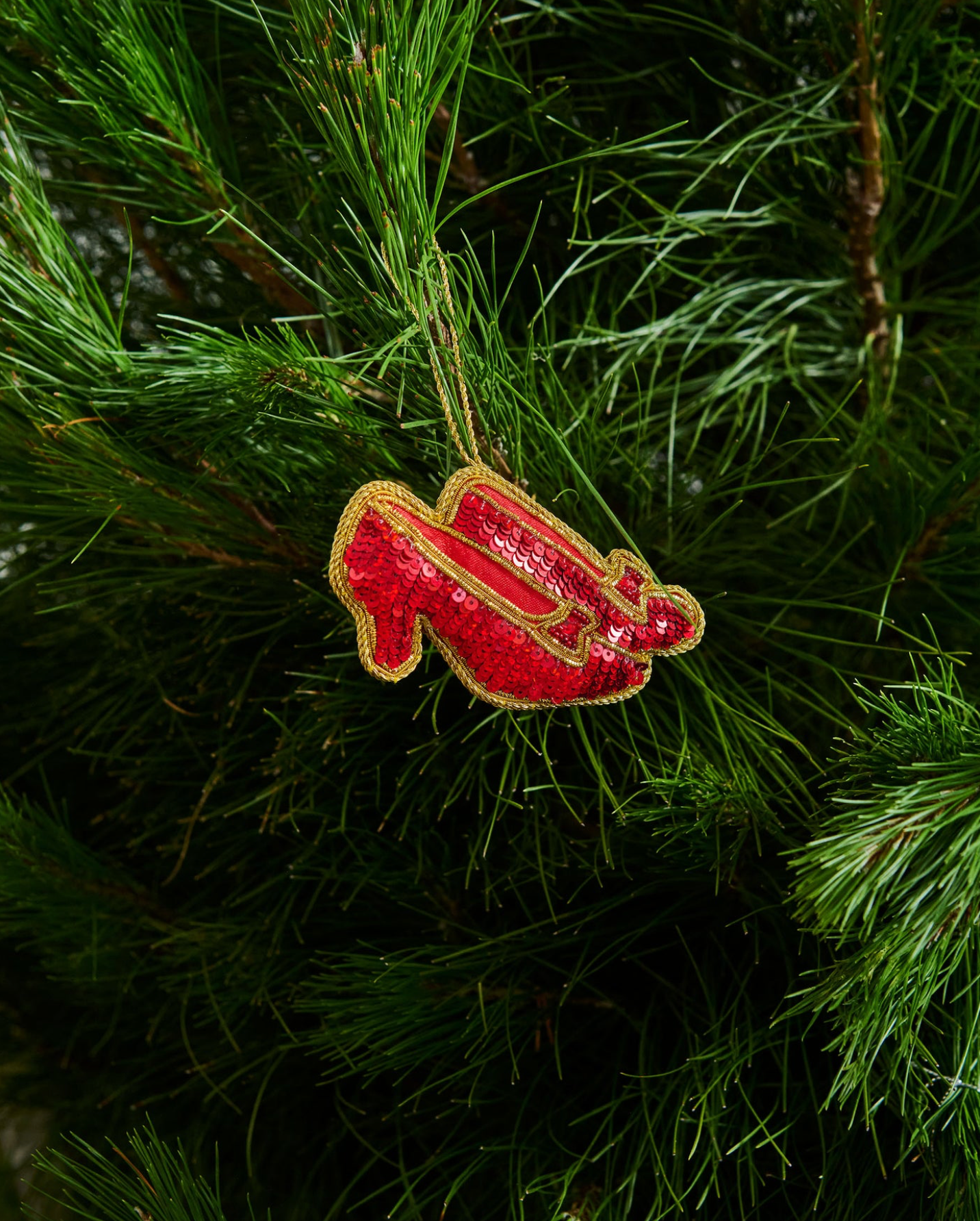 Red high heel shoe ornament on a Christmas tree