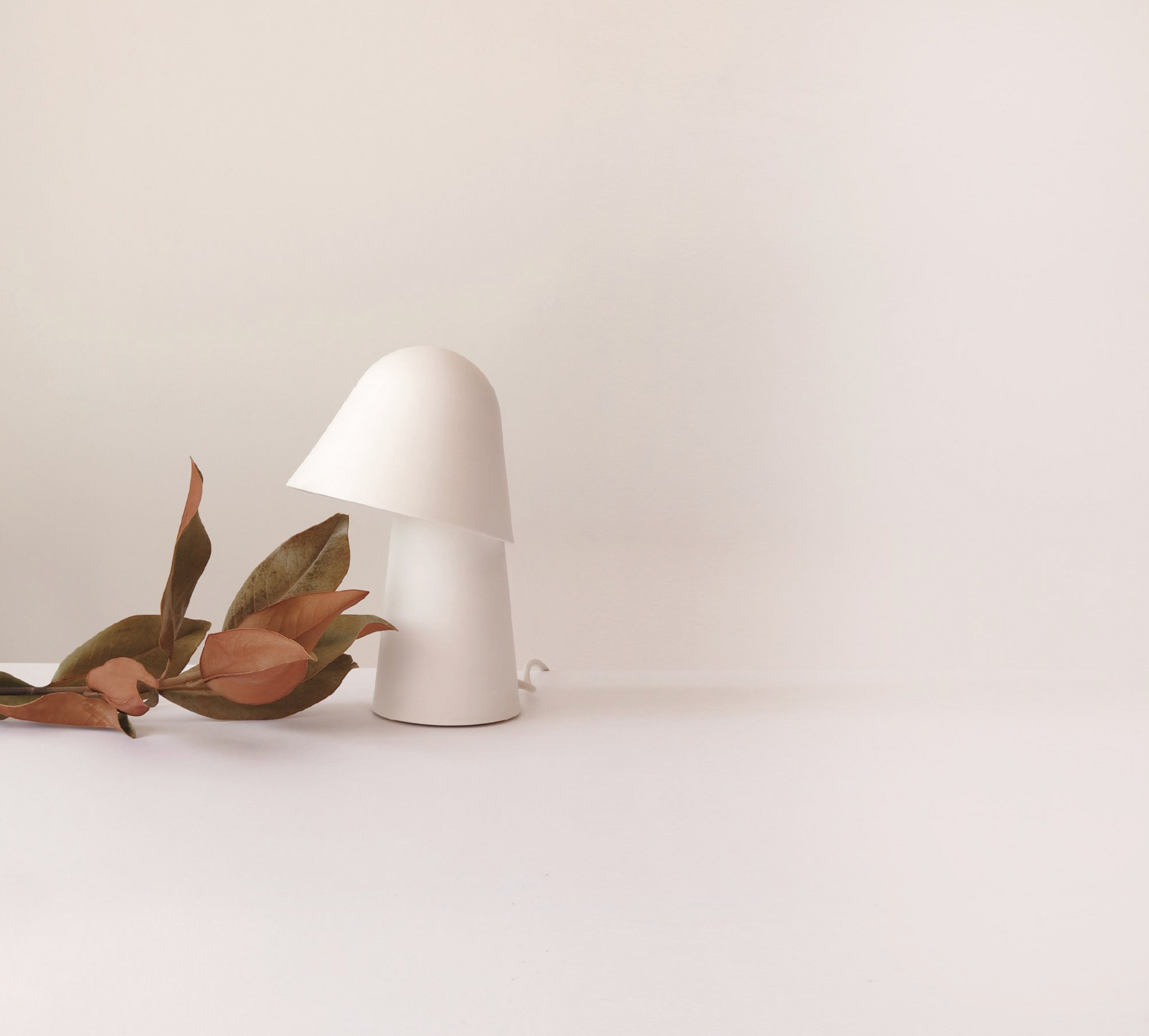 White lamp on a white surface with a minimal background