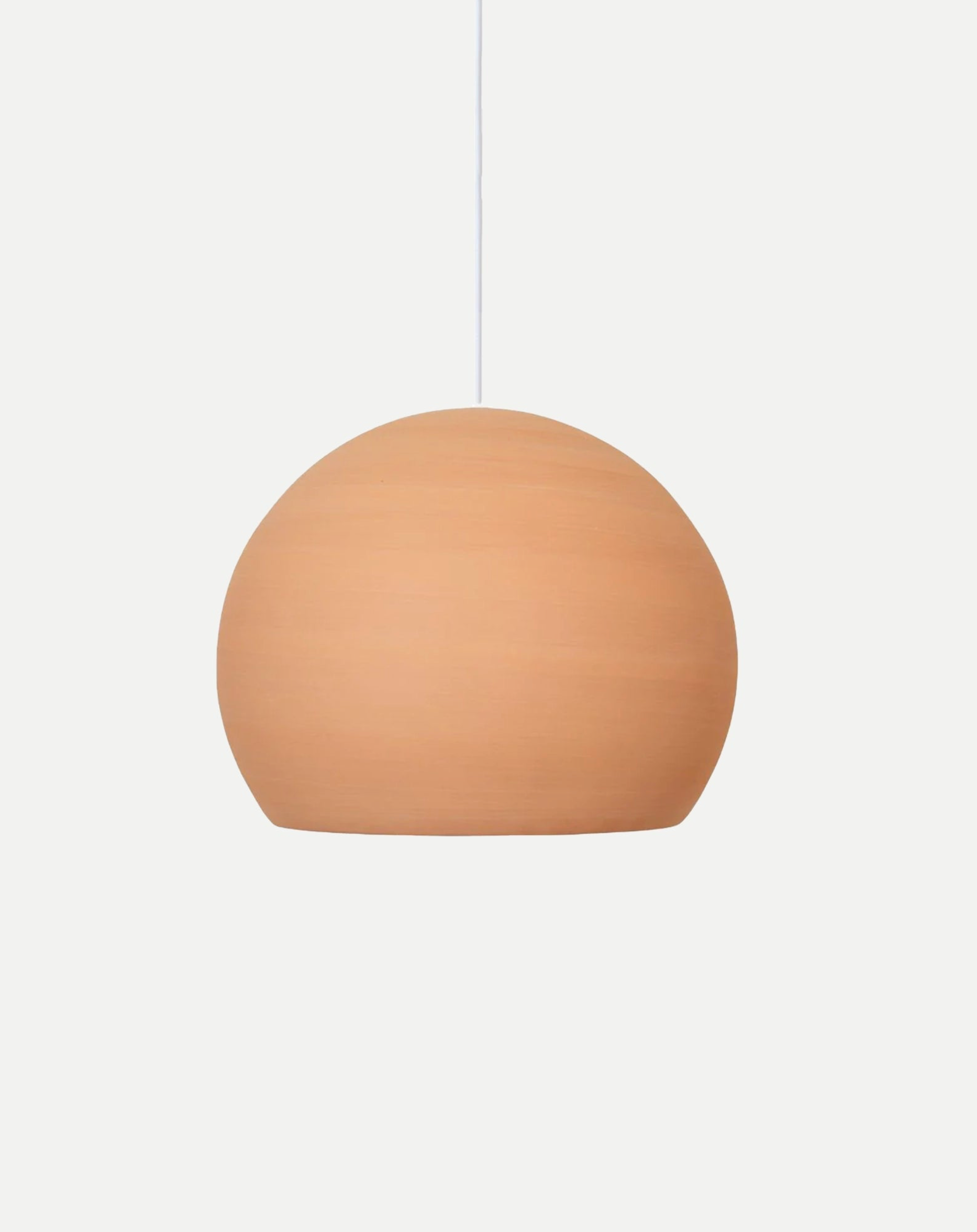 Round terracotta pendant light on a white background