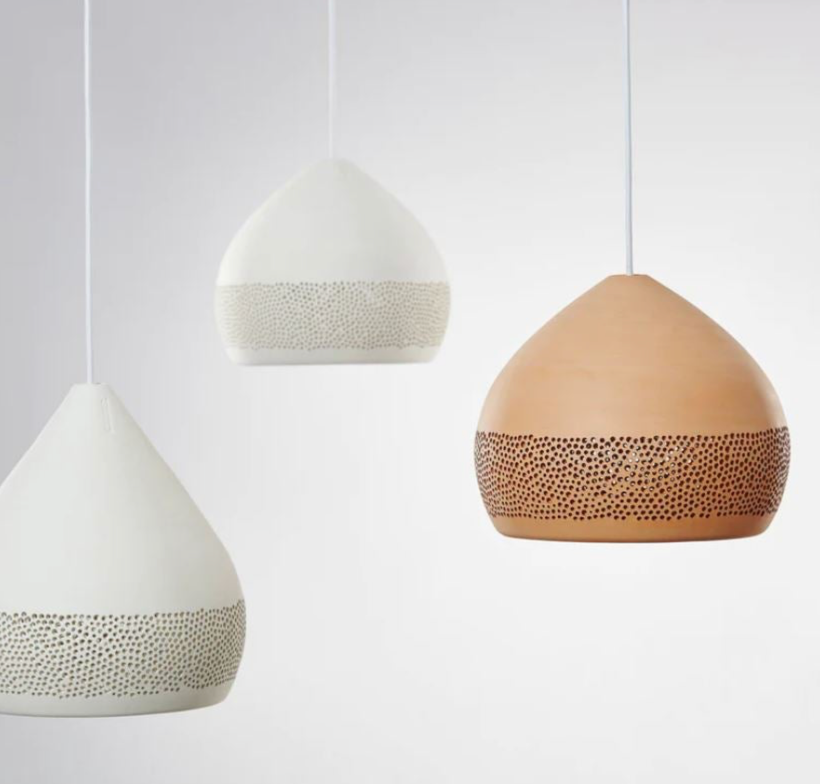 Three ceramic pendant lights on a white background