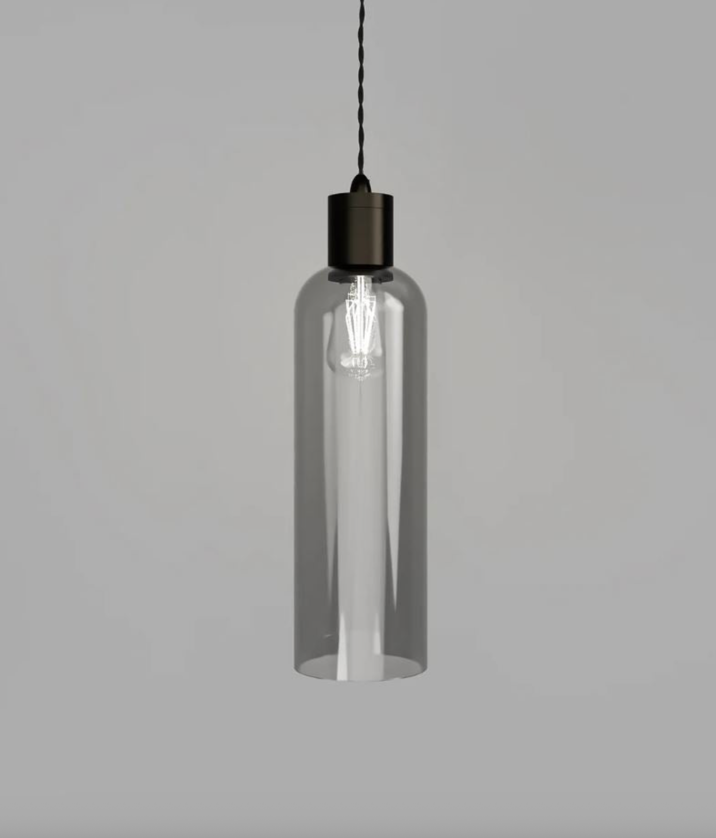 Clear cylindrical pendant light with black fixture on a gray background