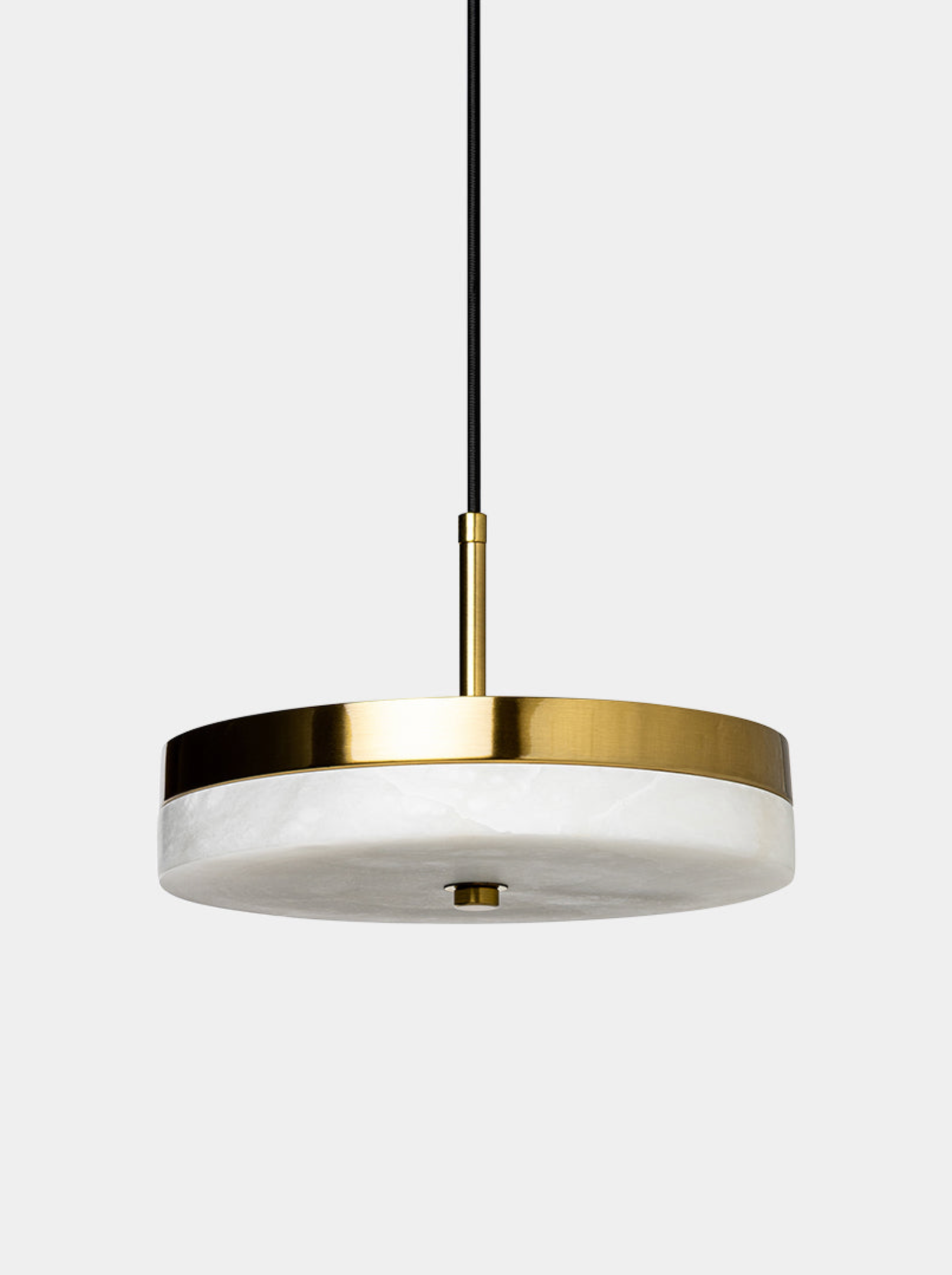 Modern pendant light with gold finish and white shade on a white background
