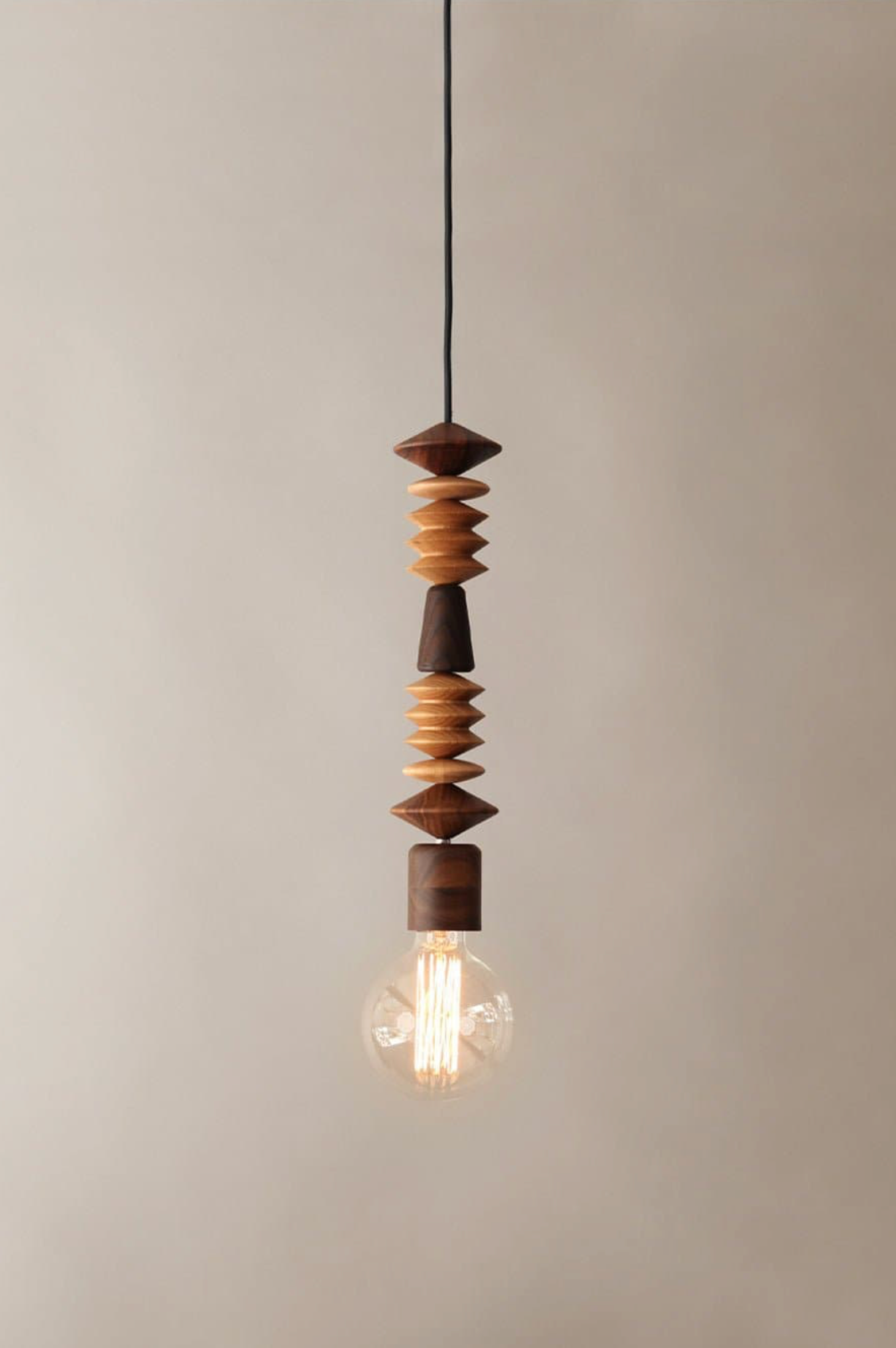 Pendant light with wooden beads on a neutral background