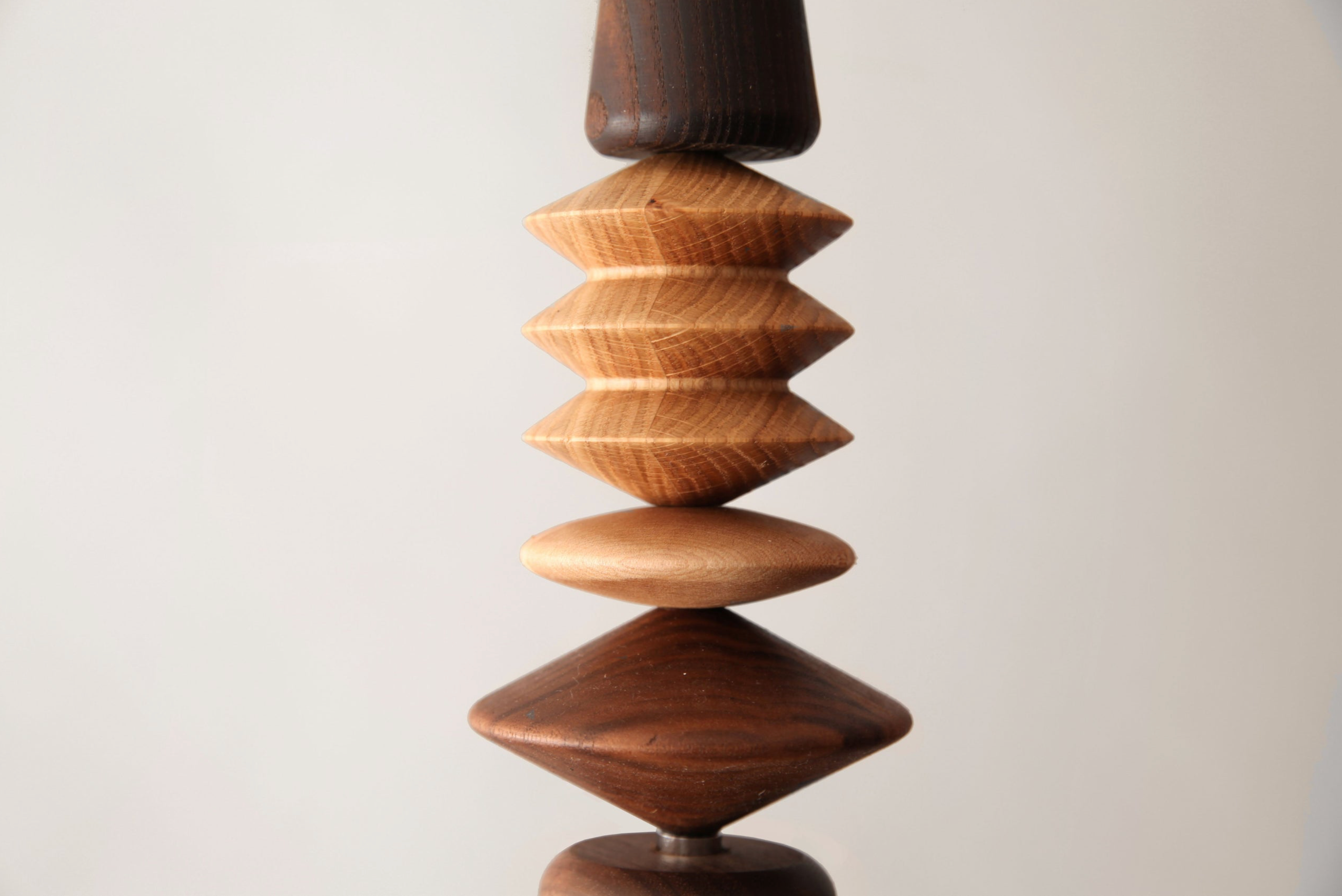 Wooden geometric sculpture on a plain background