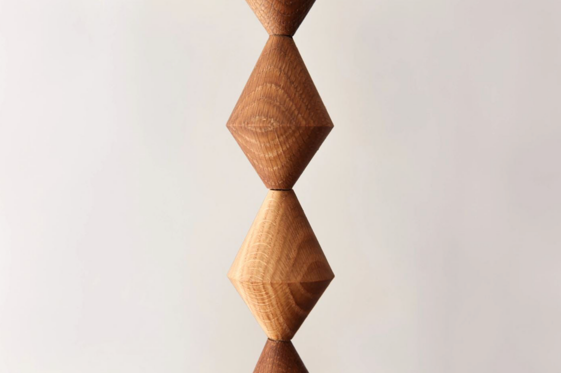 Wooden geometric sculpture on a light gray background
