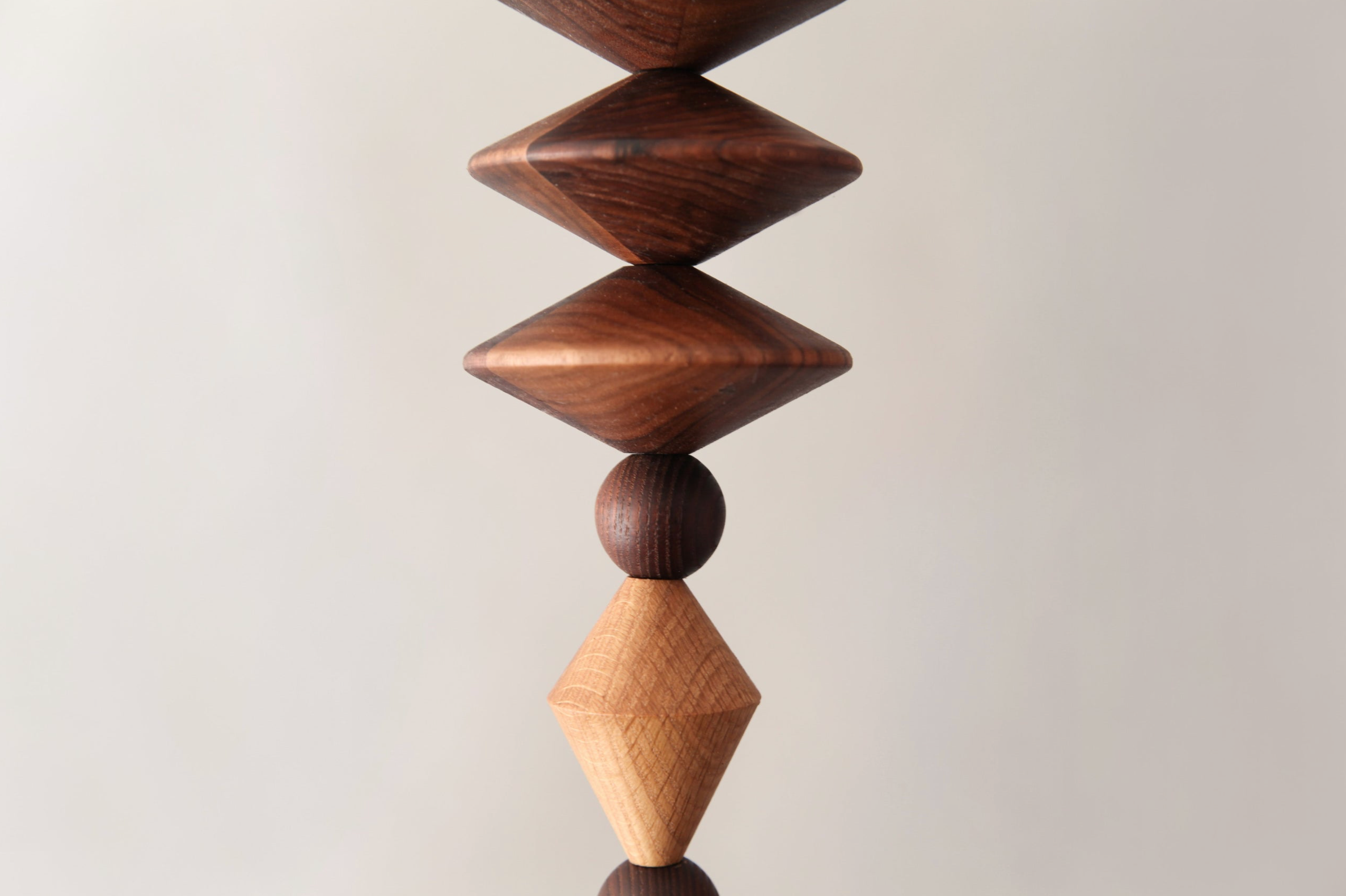 Wooden geometric sculpture on a light gray background
