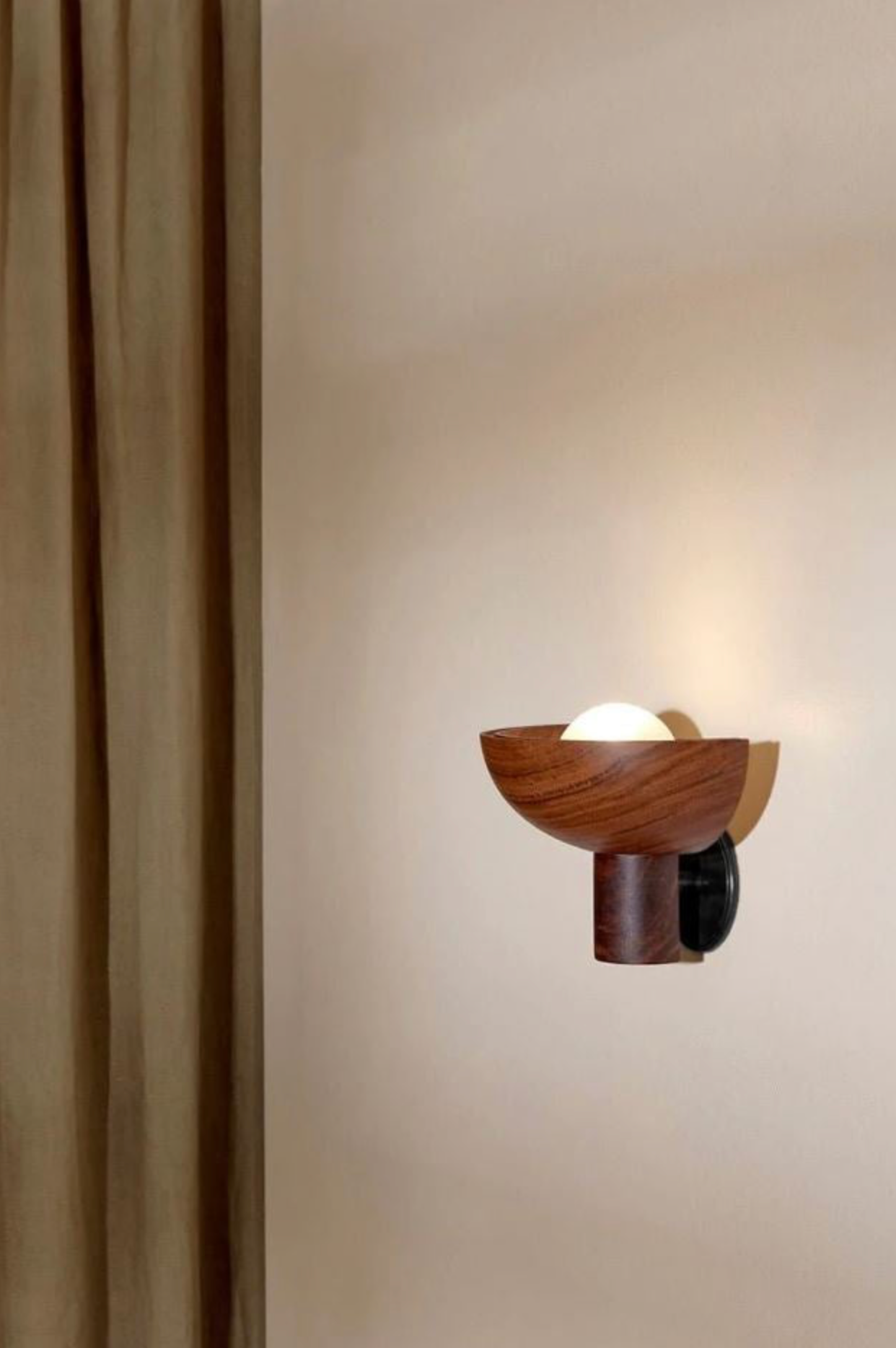 Wooden wall sconce on a beige wall