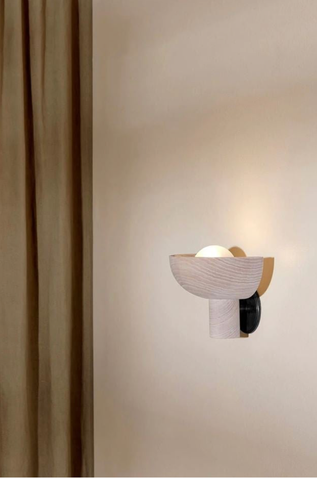 Modern wall-mounted light fixture on a neutral wall