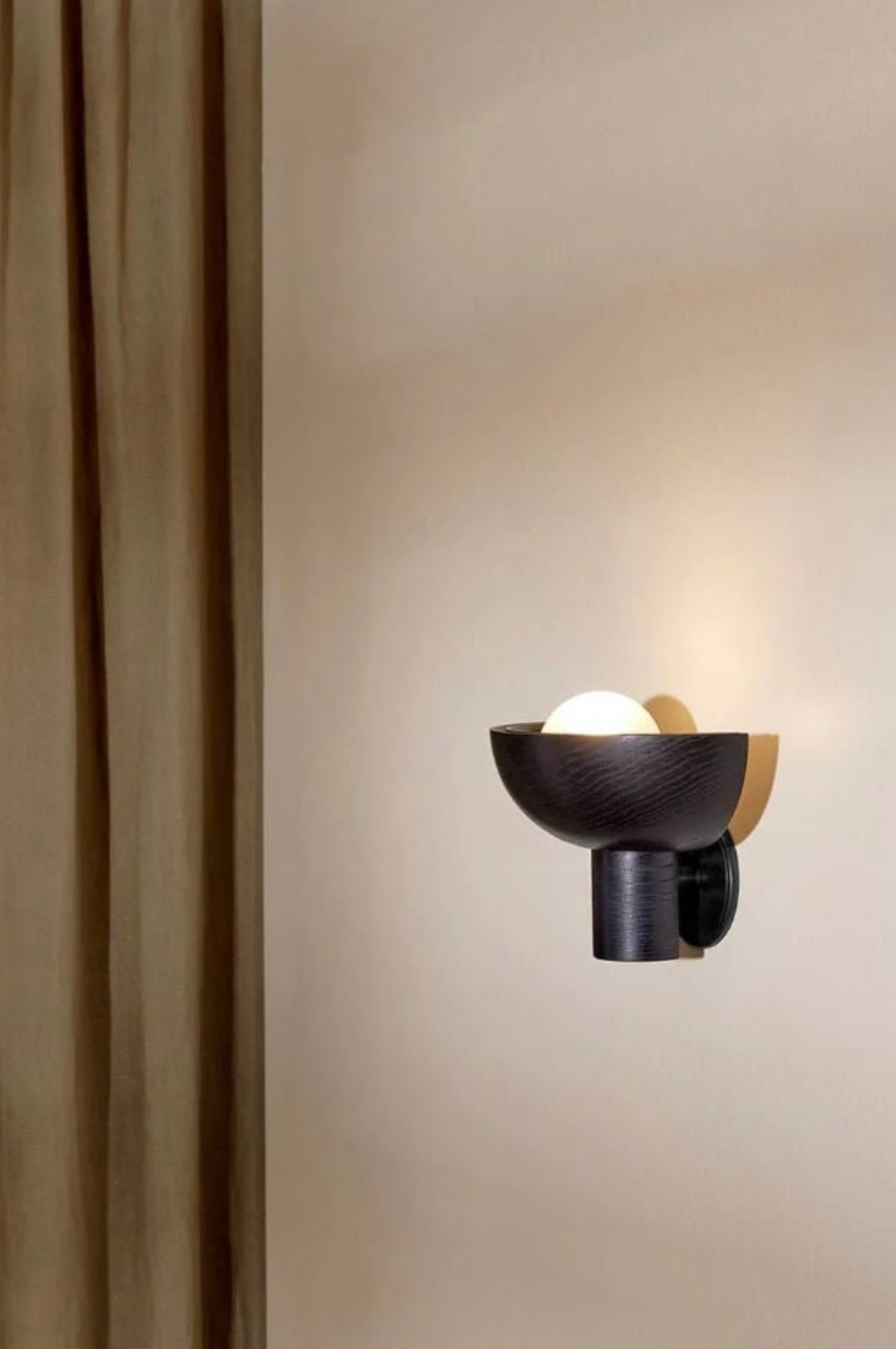 Modern wall-mounted light fixture on a neutral wall
