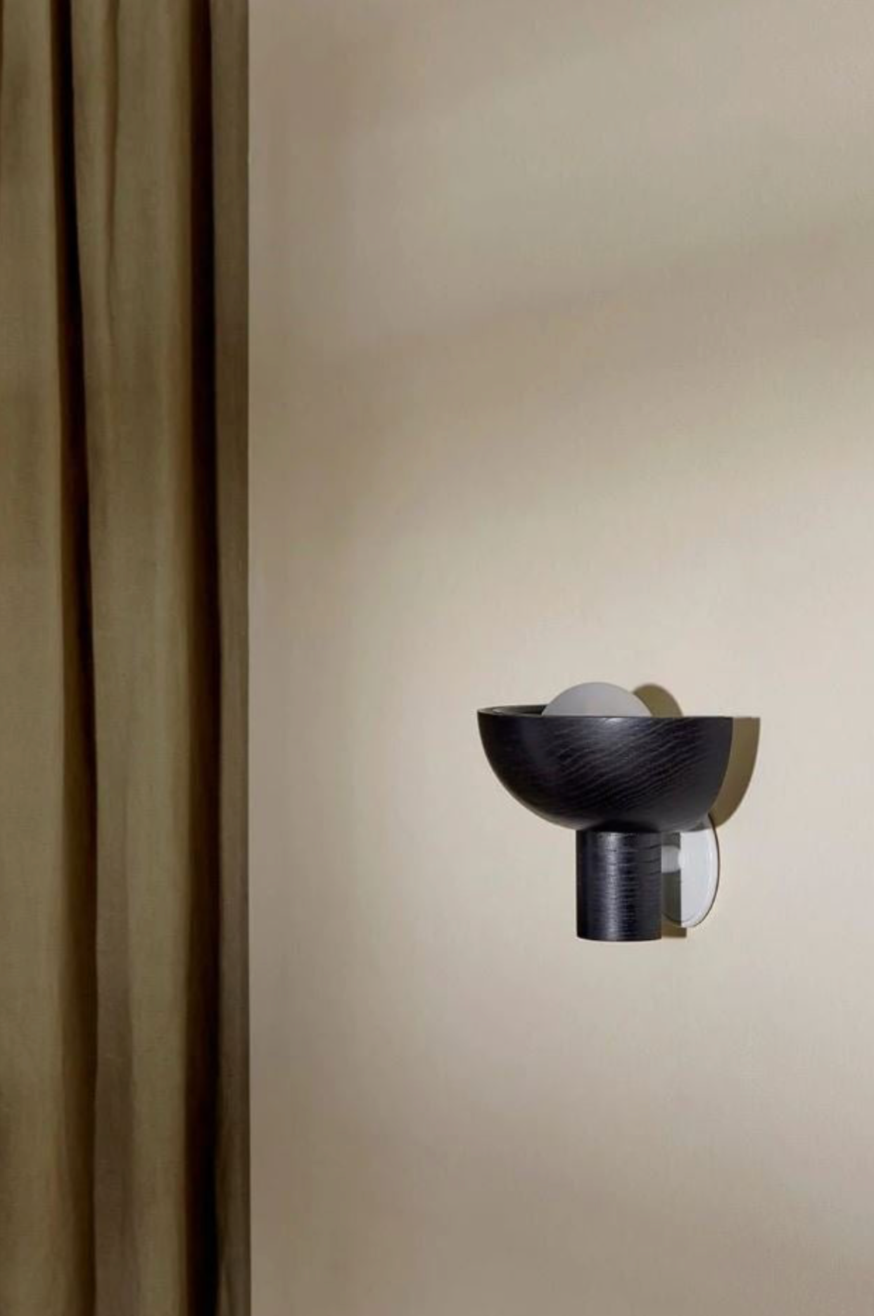 Modern wall-mounted light fixture on a neutral wall