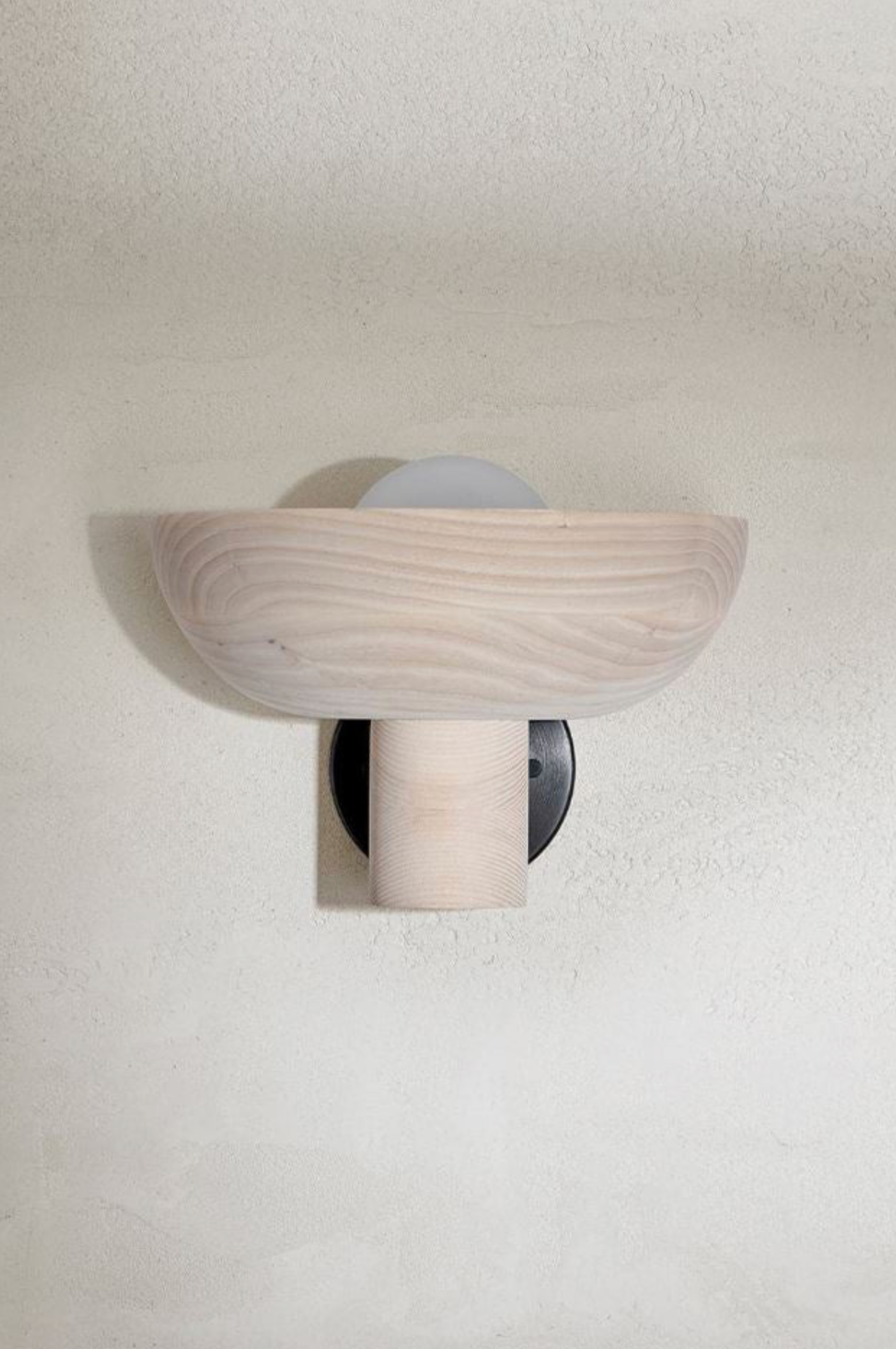 Wooden wall sconce on a white wall