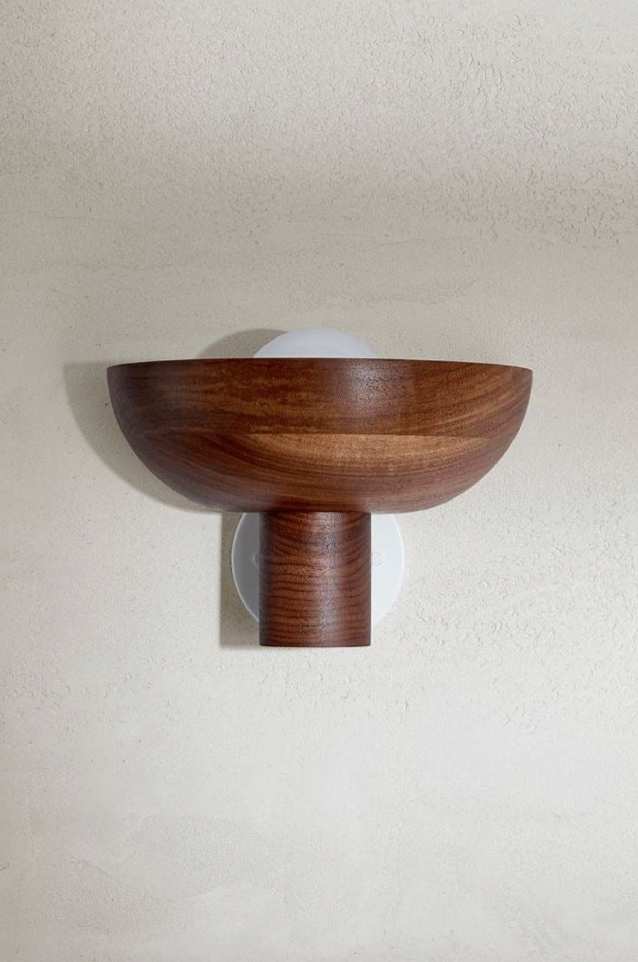 Wooden wall sconce on a plain wall