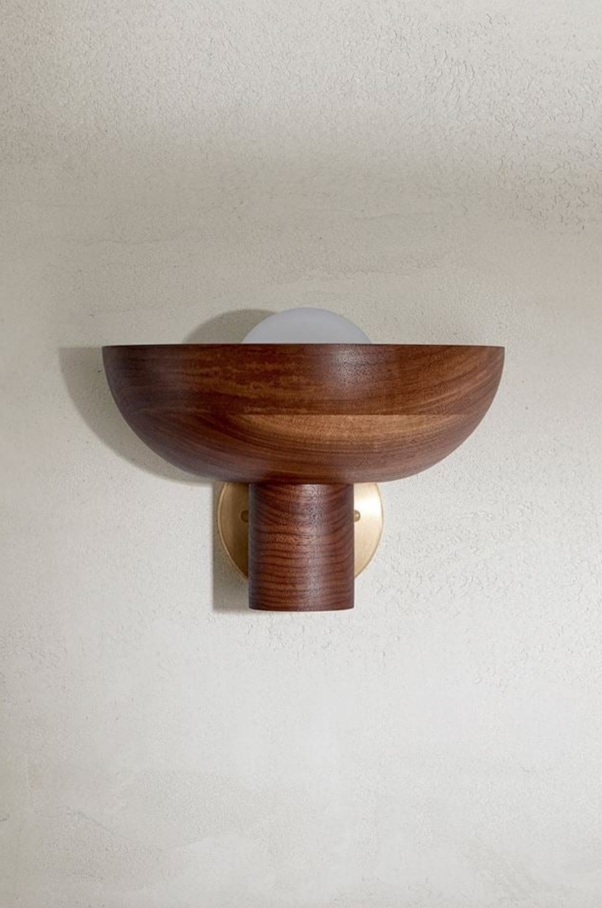 Wooden wall sconce on a plain wall