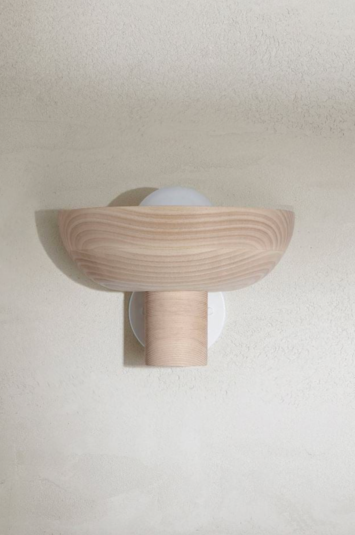 Wooden wall sconce on a plain wall