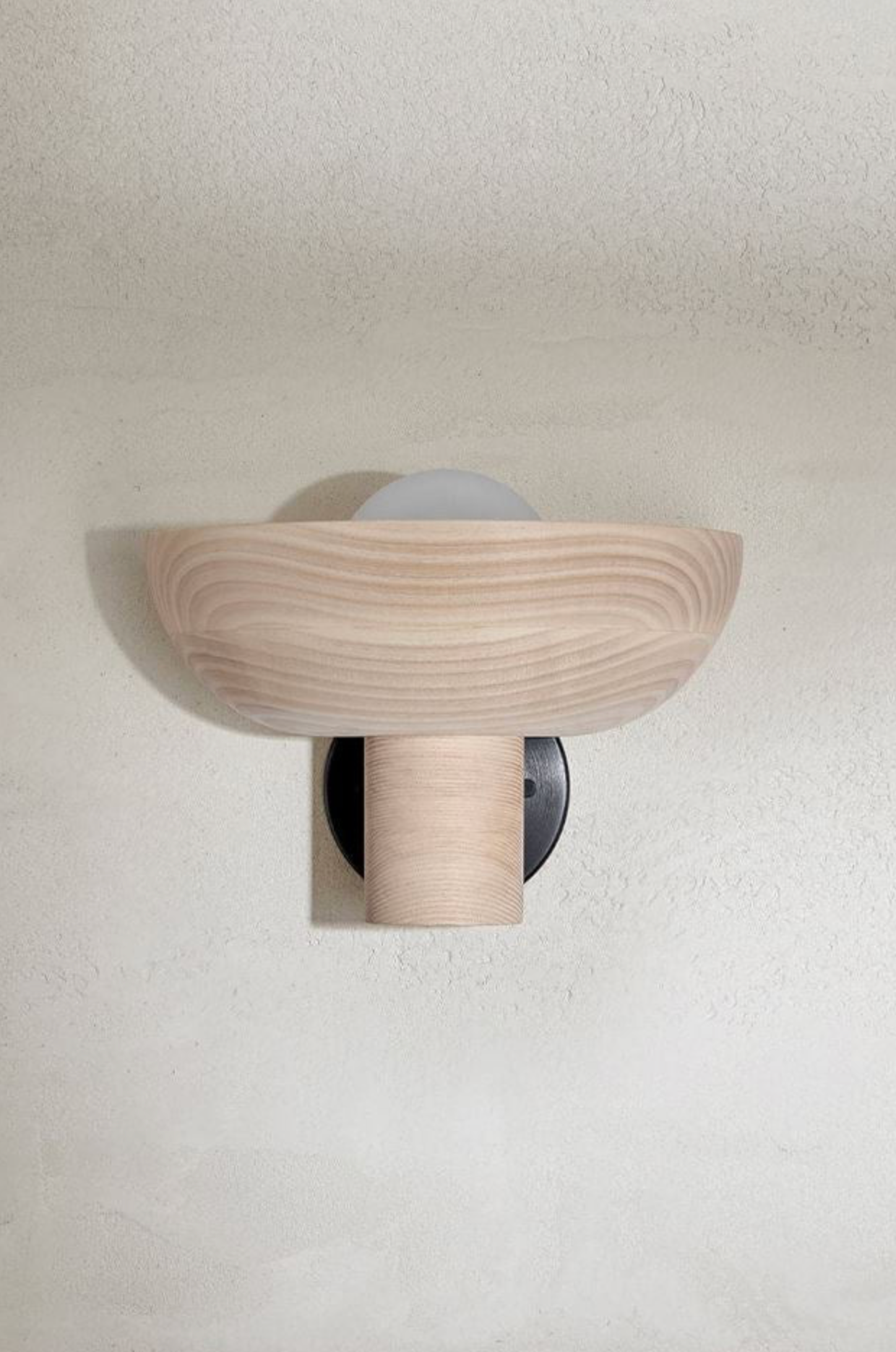 Wooden wall sconce on a white wall