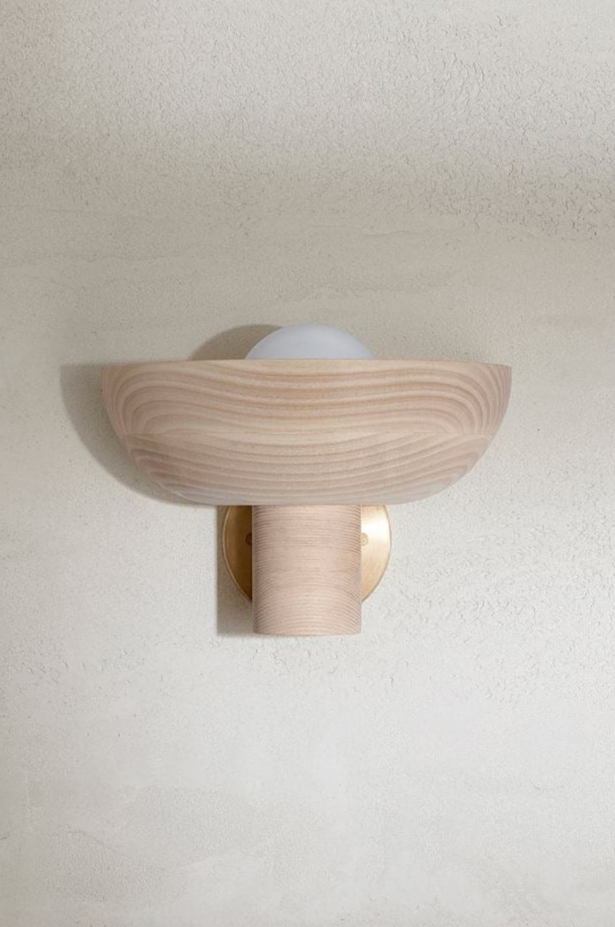Wooden wall sconce on a plain wall