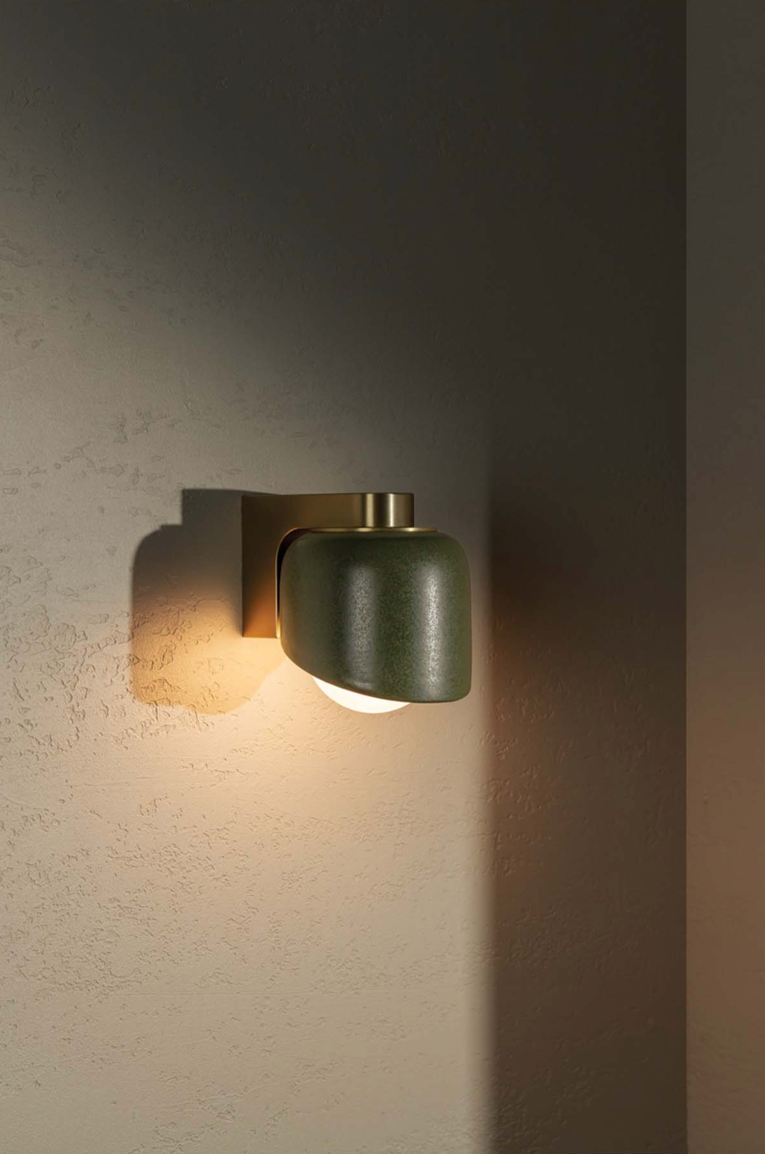 Modern wall-mounted light fixture on a textured wall