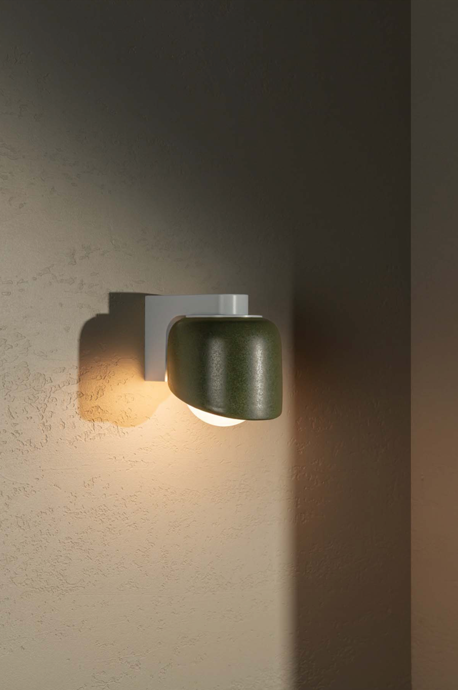 Modern wall-mounted light fixture on a textured wall