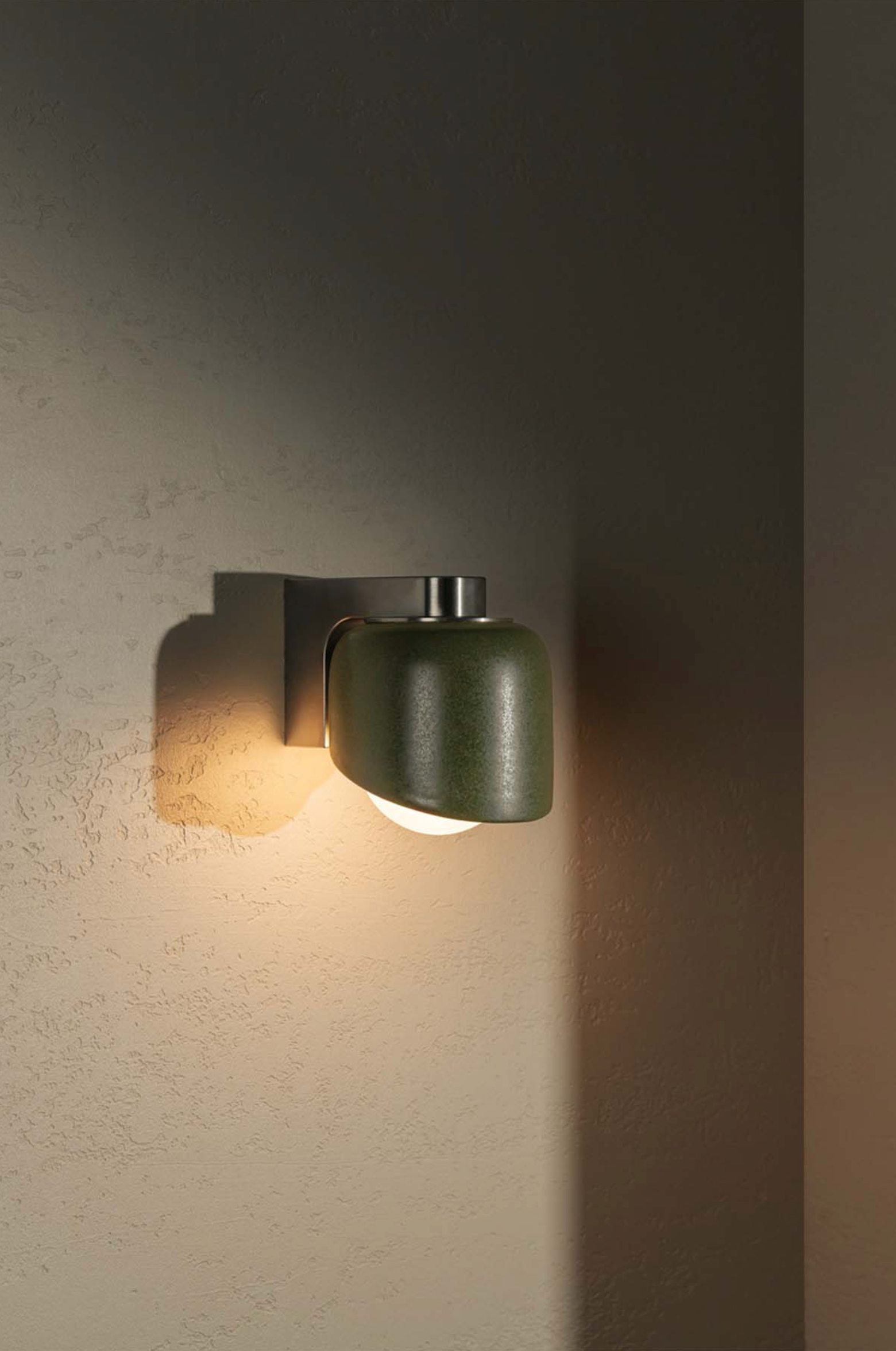 Modern wall-mounted light fixture on a textured wall