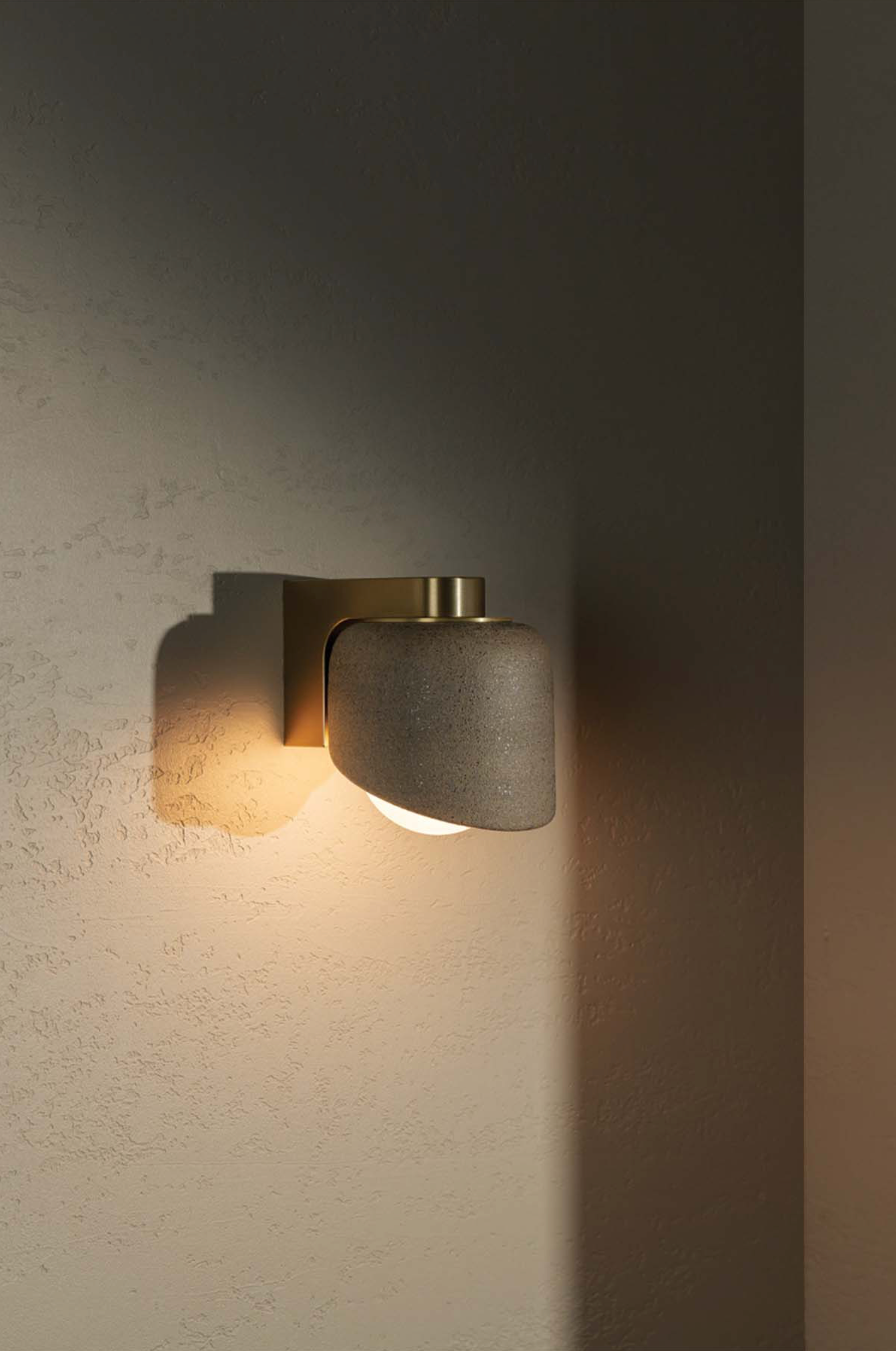 Modern wall-mounted light fixture on a textured wall