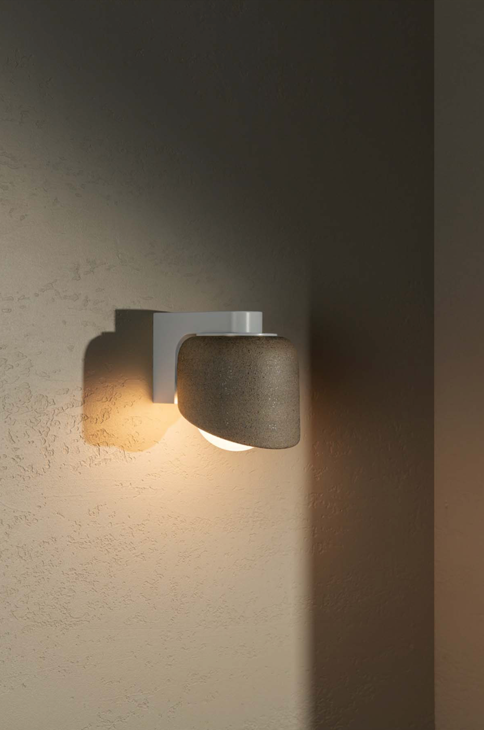 Modern wall-mounted light fixture on a textured wall