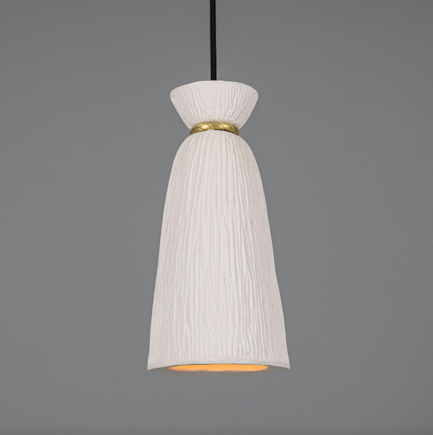 White pendant light with gold accent on a gray background