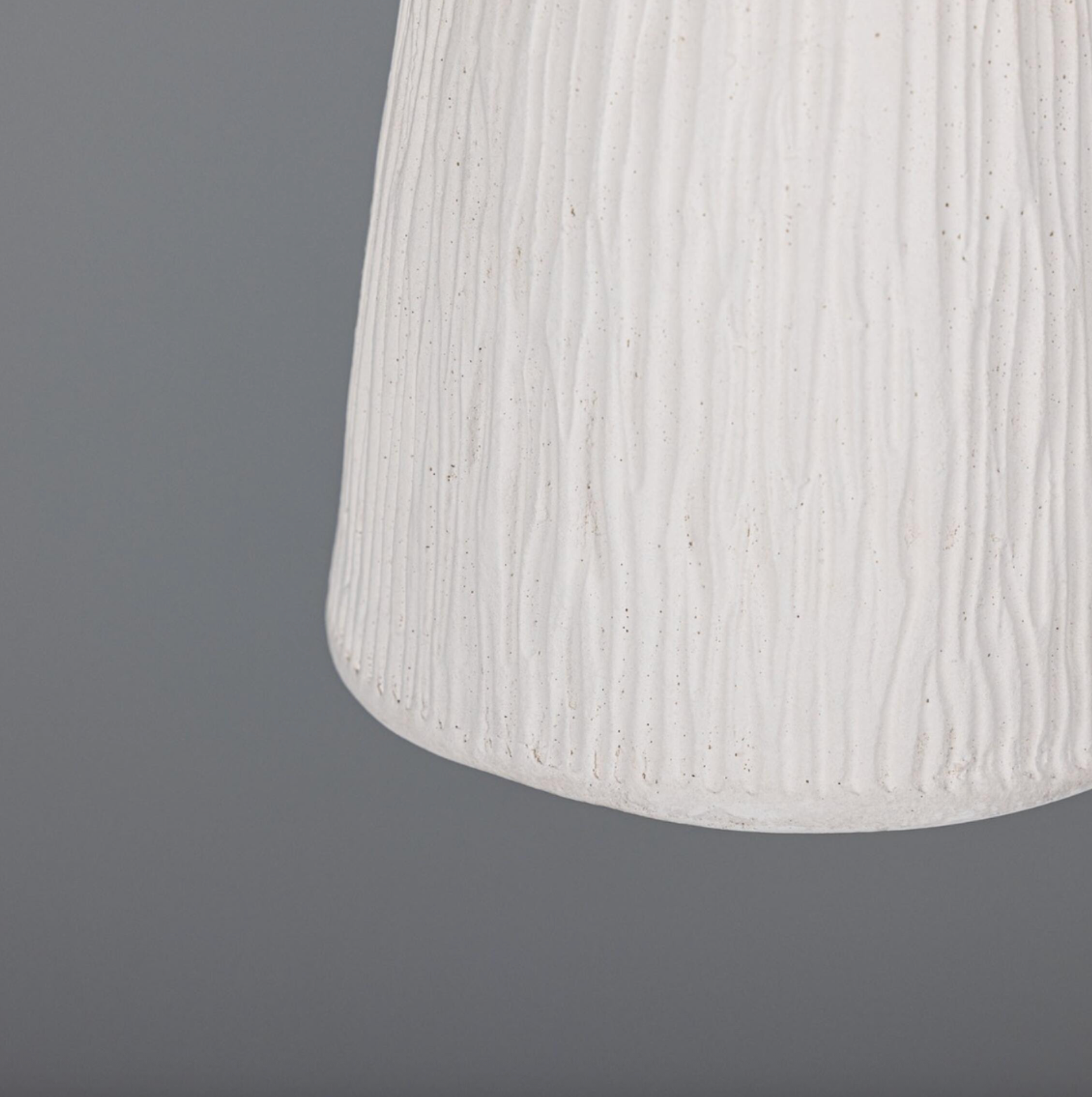 Textured white lampshade on a dark gray background
