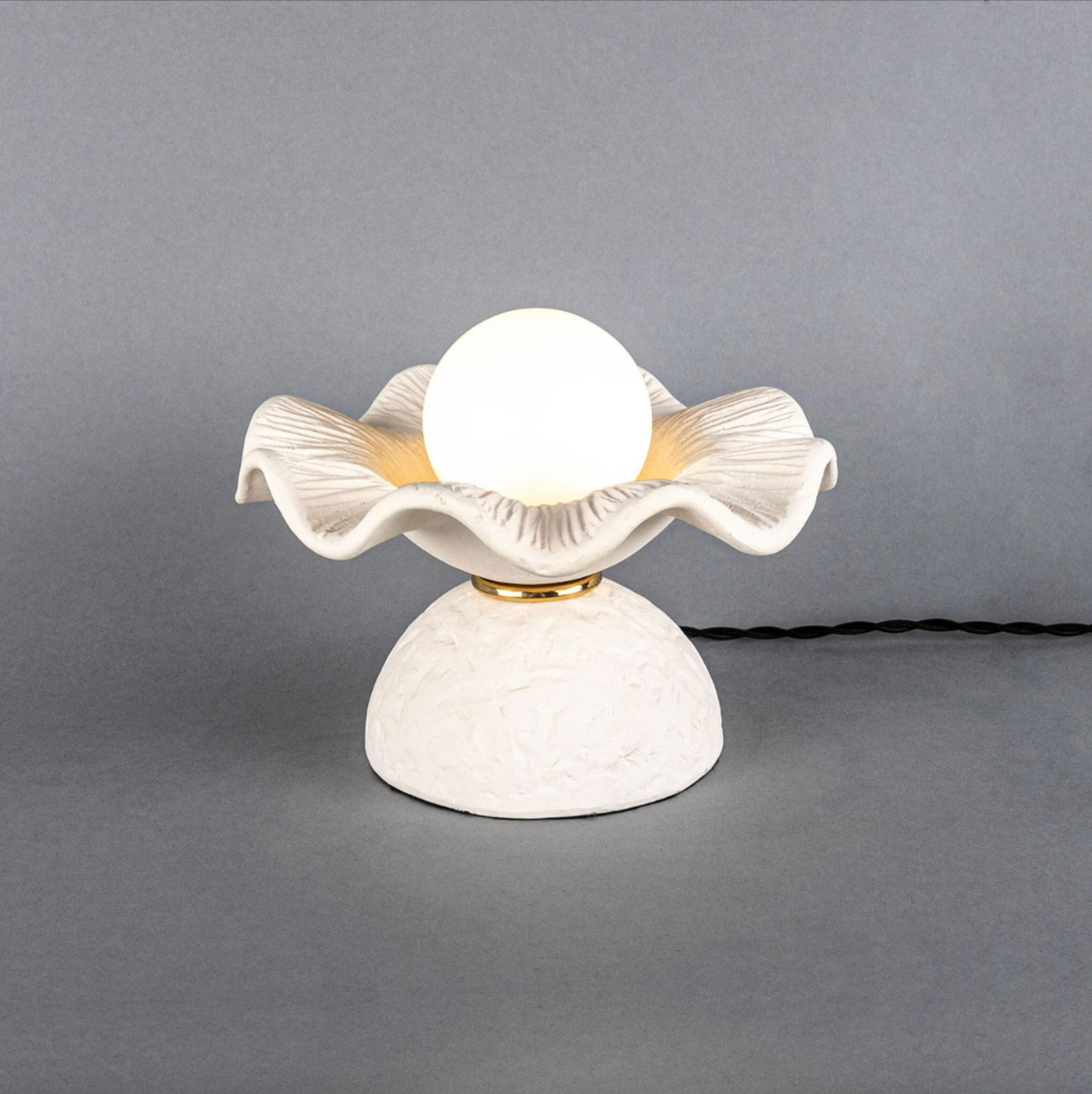White table lamp with decorative design on a gray background