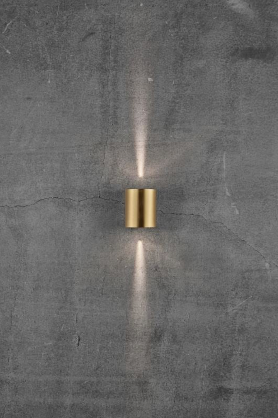 Modern wall-mounted light fixture on a textured grey wall