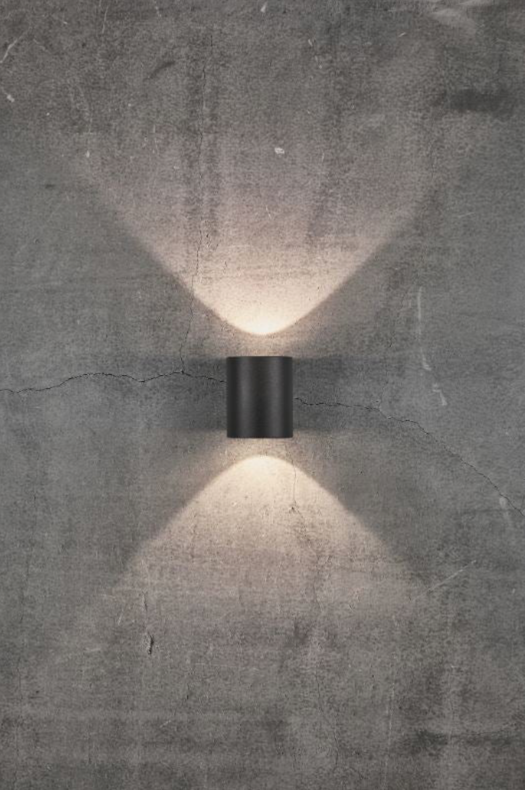 Wall-mounted outdoor light fixture on a concrete wall