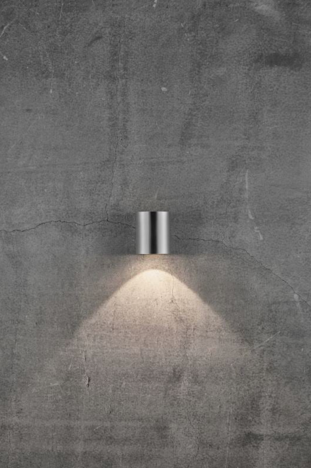Wall-mounted outdoor light fixture on a concrete wall