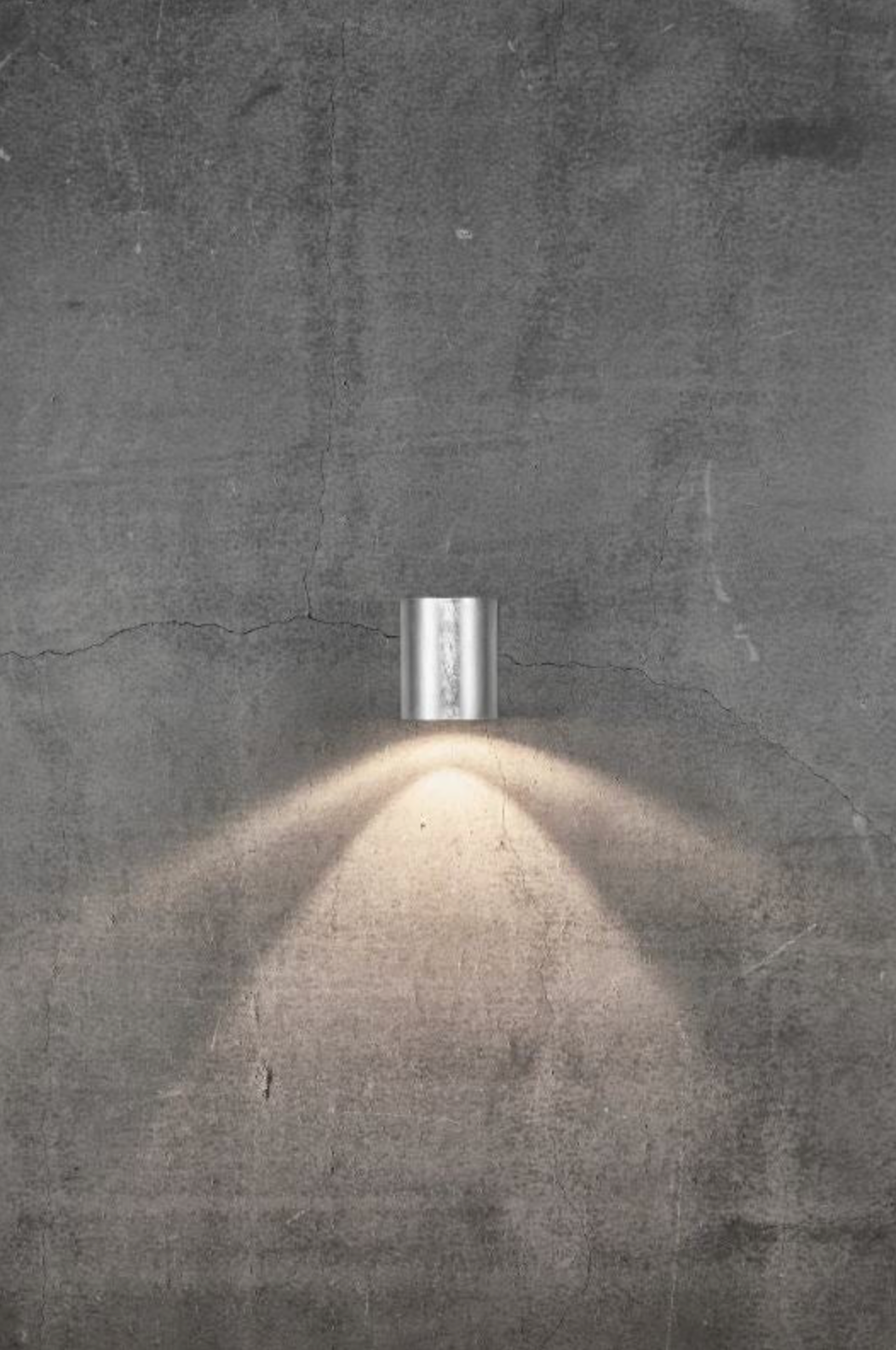 Modern outdoor wall light fixture on a textured concrete wall