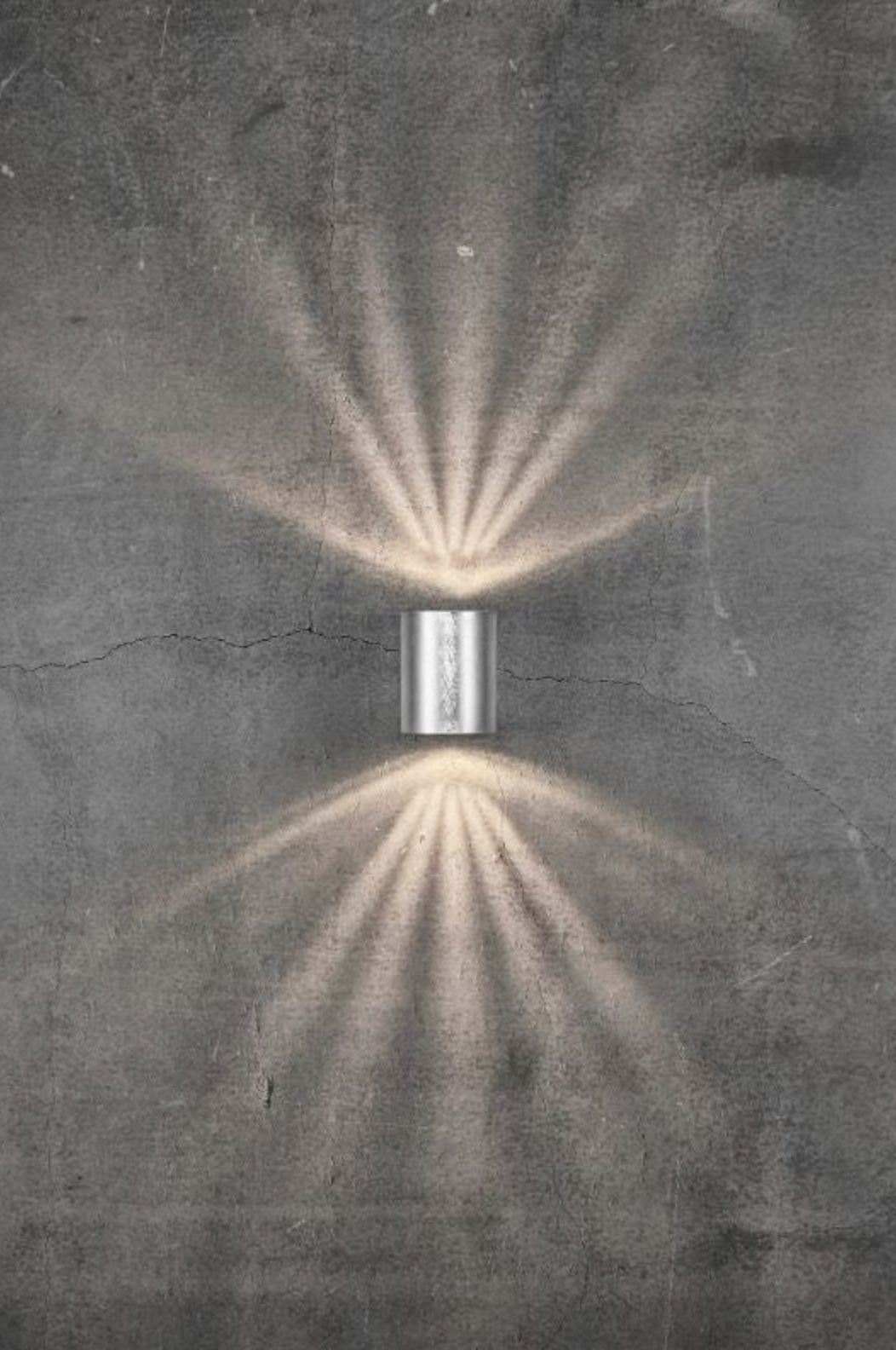 Light fixture casting a pattern on a textured wall