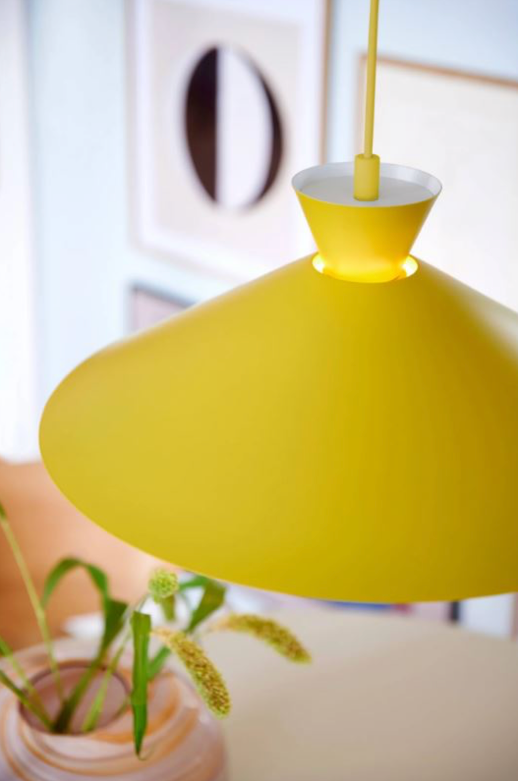Yellow pendant lamp with a blurred indoor background