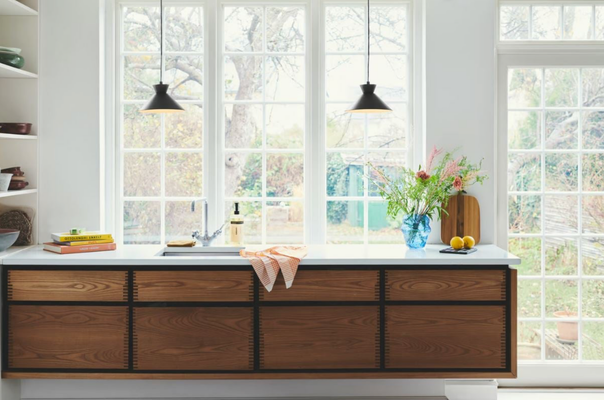 Modern kitchen with wooden cabinets and a window view