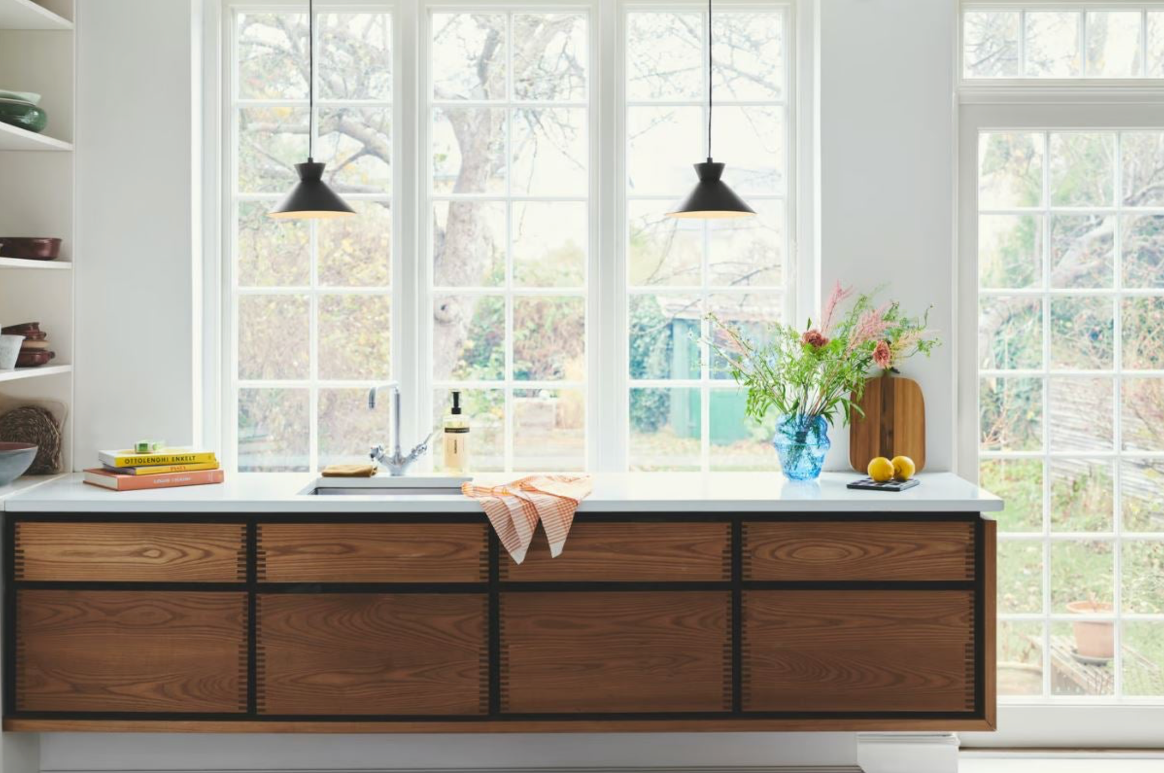 Modern kitchen with wooden cabinets and a window view