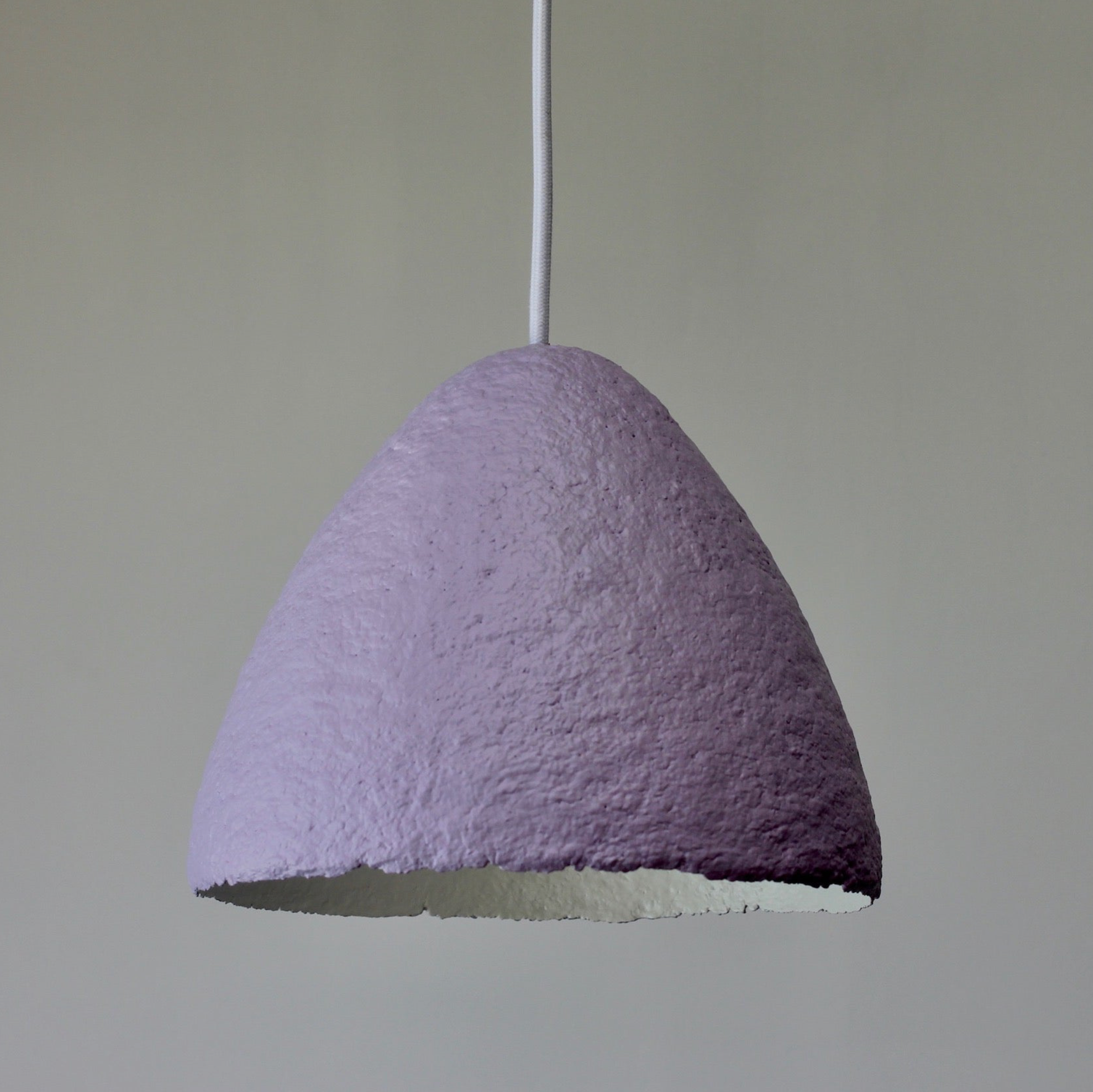 Textured purple pendant light against a plain background