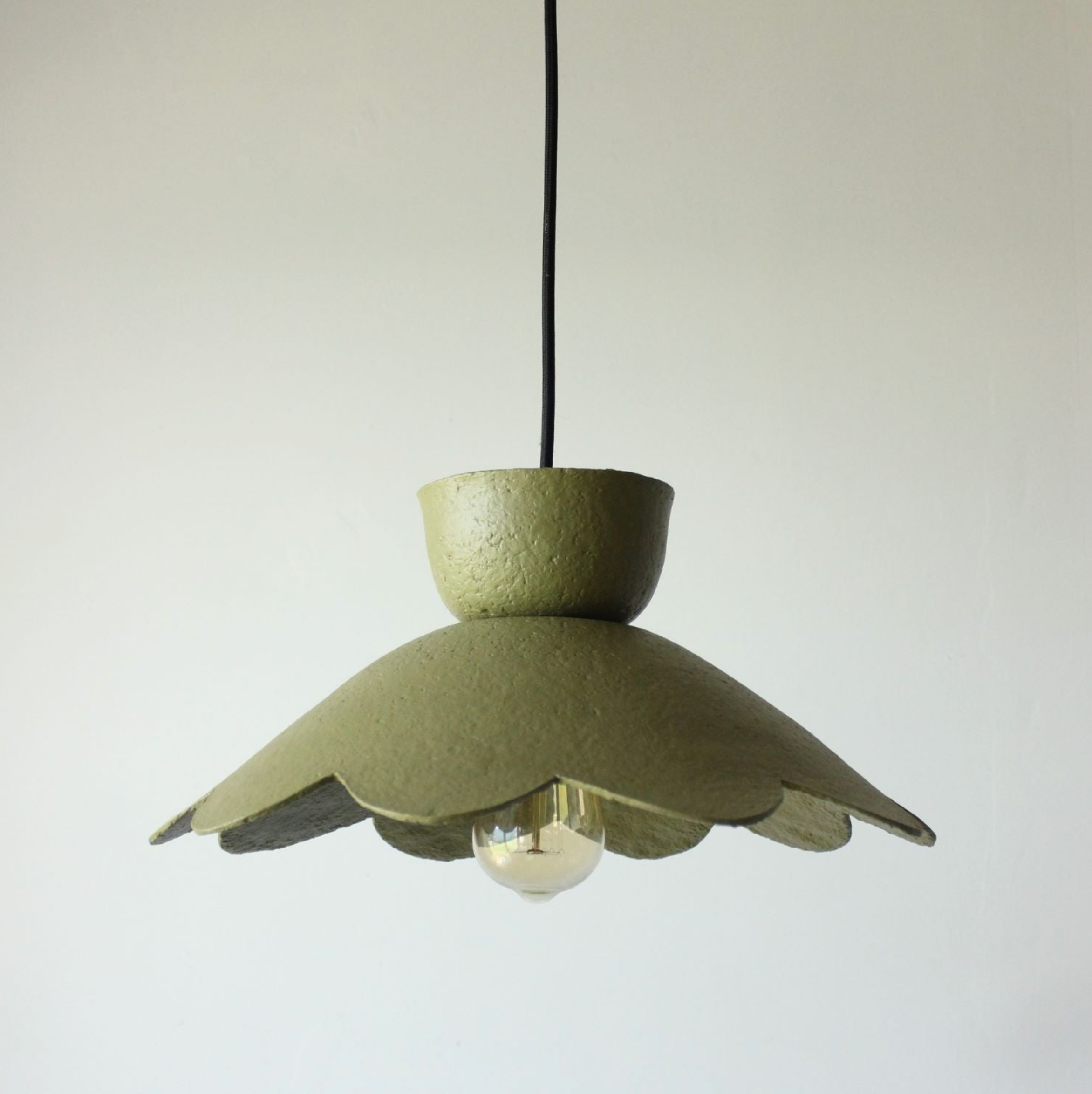 Green pendant lamp on a white background