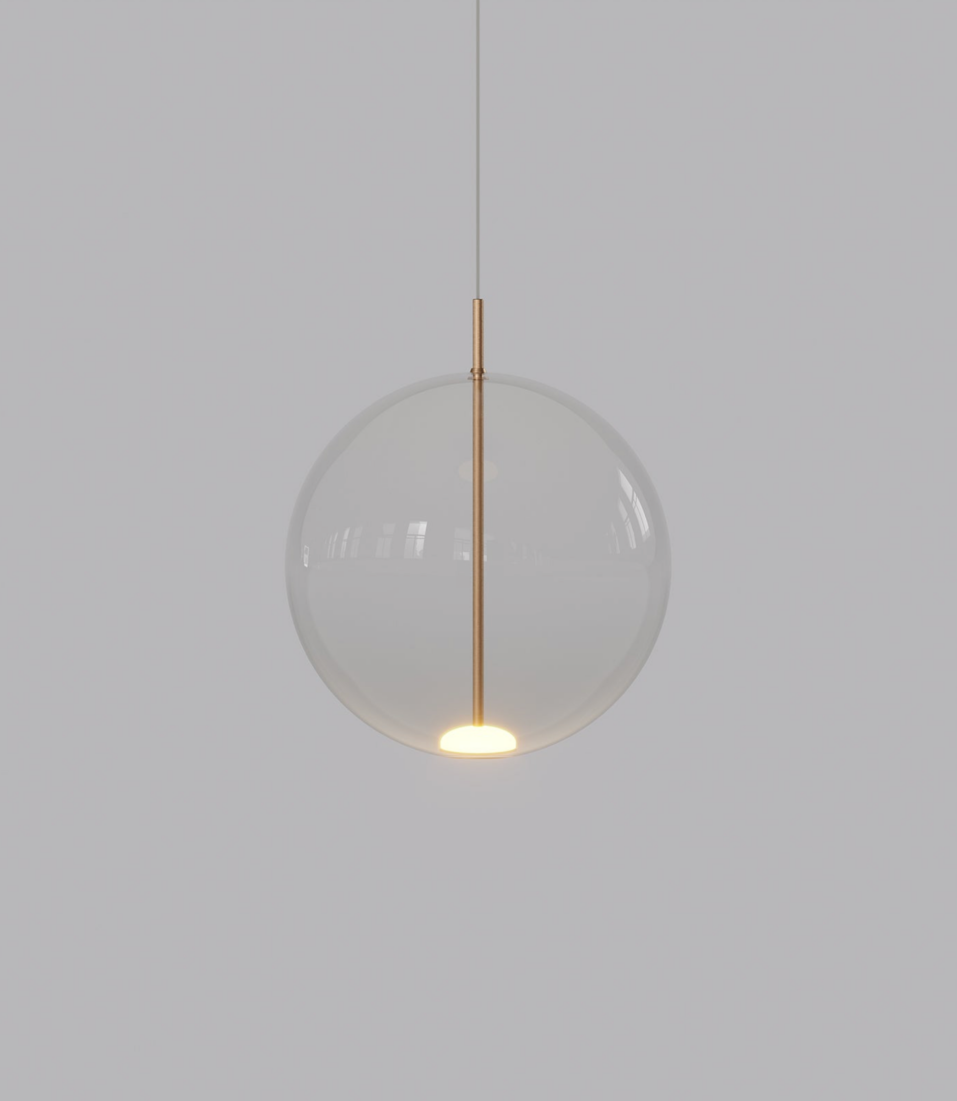 Spherical pendant light with a clear glass shade and gold fixture on a plain background