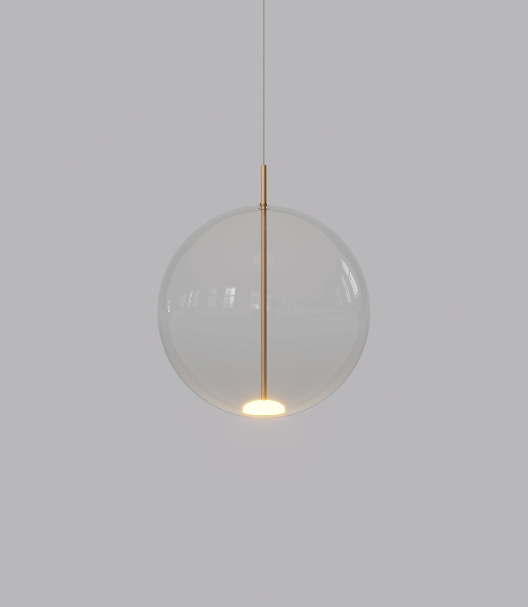 Spherical pendant light with a clear glass shade and gold fixture on a plain background