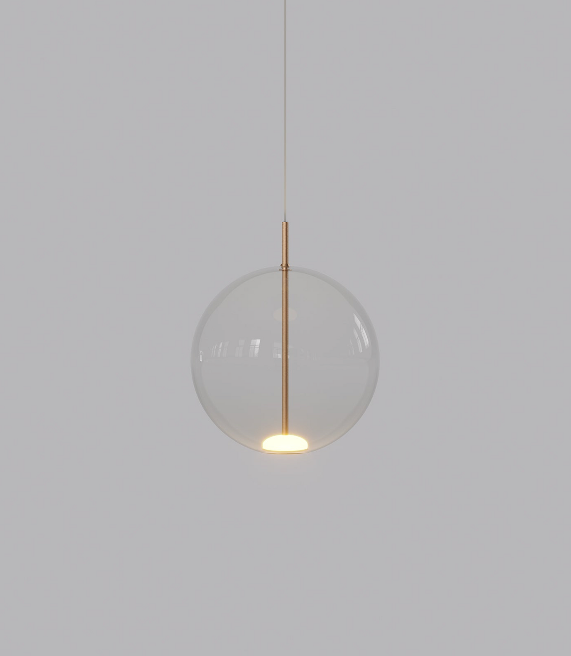 Spherical glass pendant light with a gold fixture on a plain background