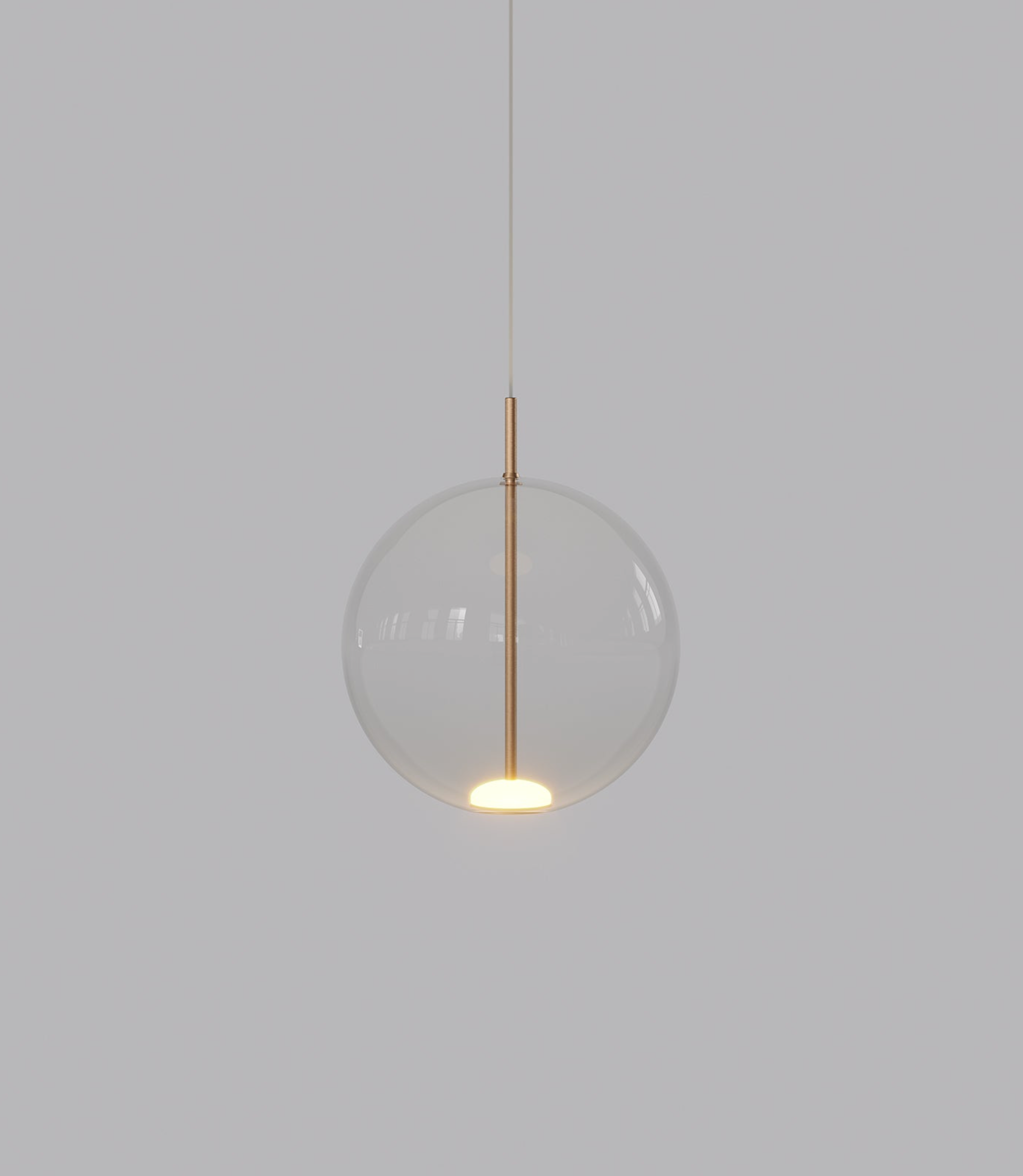 Spherical glass pendant light with a gold fixture on a plain background