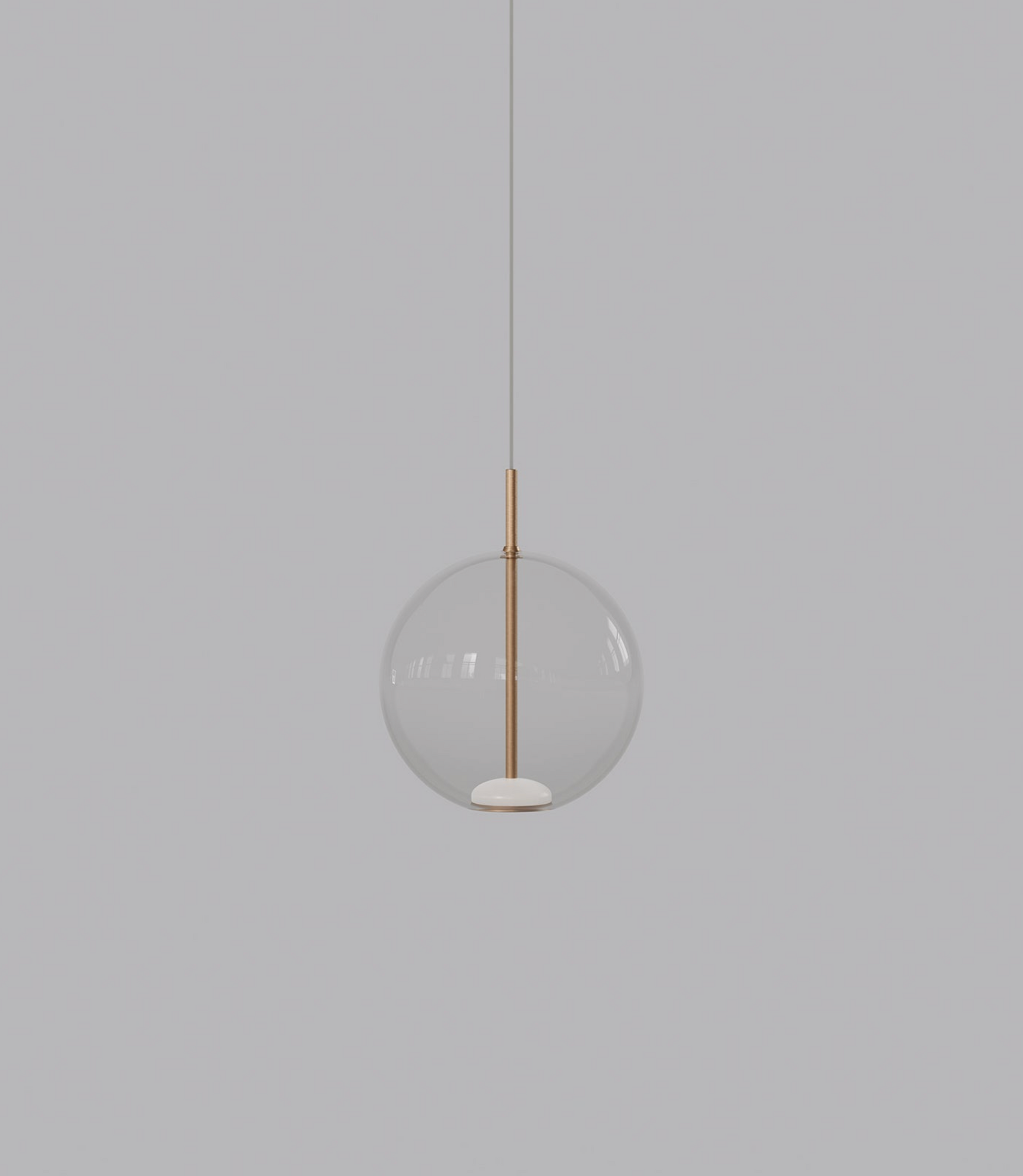 Spherical pendant light with a clear glass shade and brass fixture on a grey background