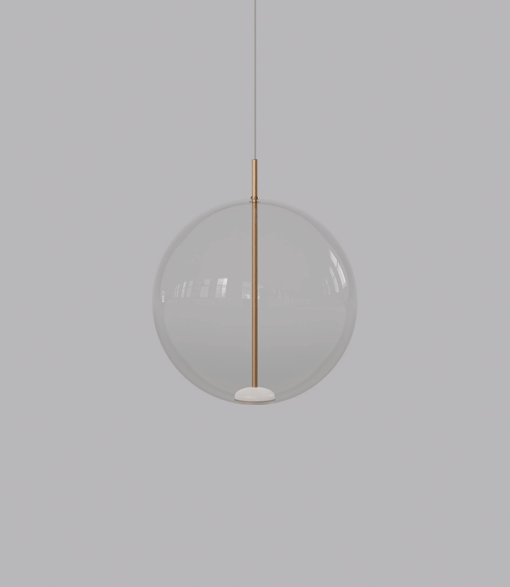 Spherical glass pendant light with a gold fixture on a grey background