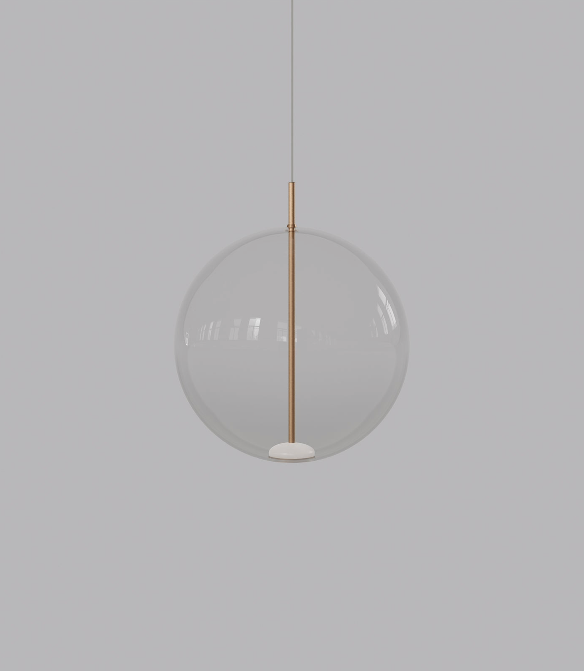 Spherical glass pendant light with a gold fixture on a grey background