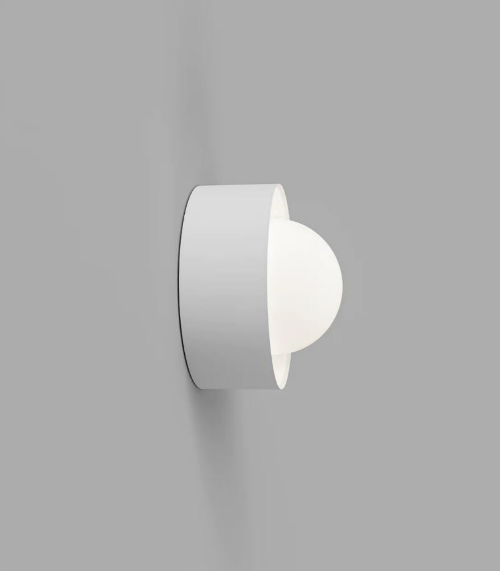 White wall-mounted light fixture on a grey background