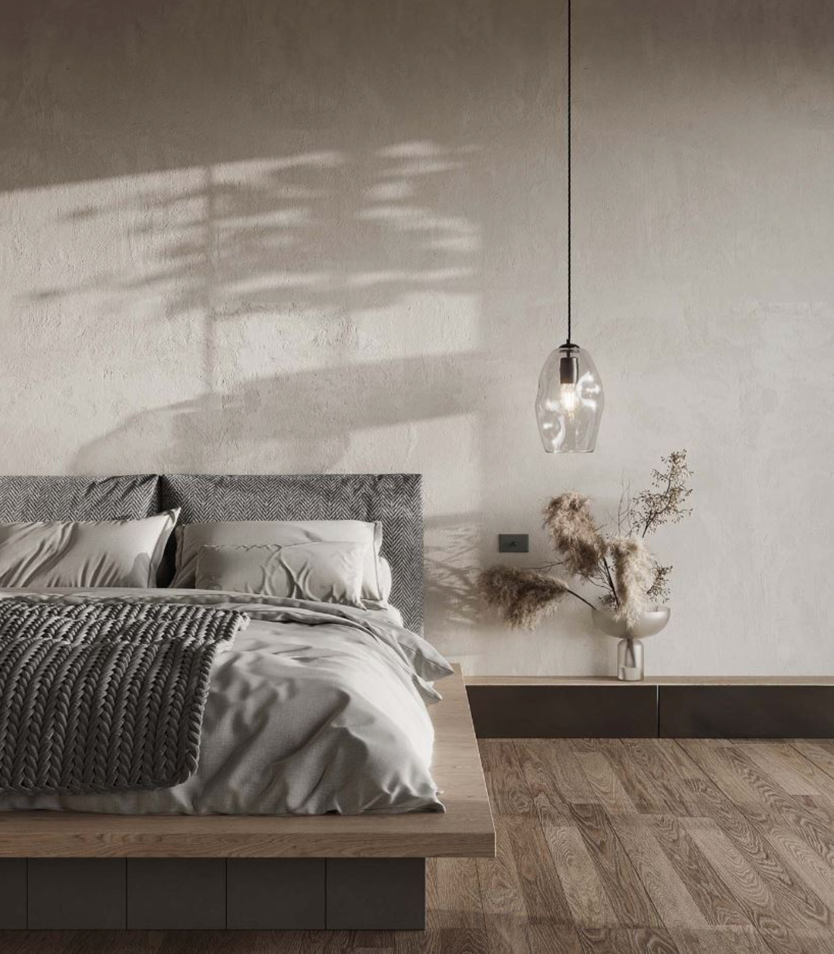 Modern bedroom with a bed, lamp, and decorative elements.