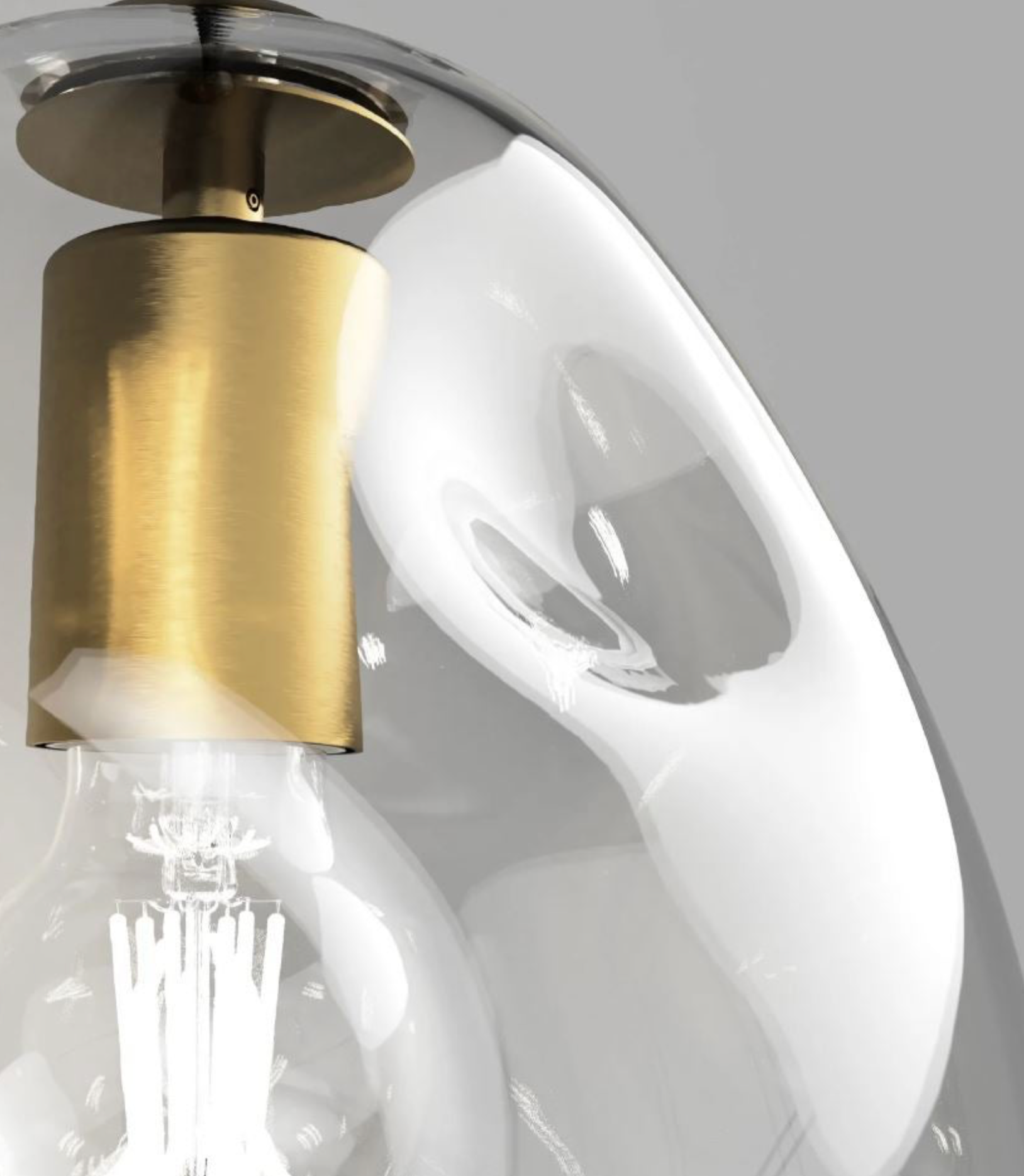 Close-up of a ceiling light fixture with gold finish and white shade.