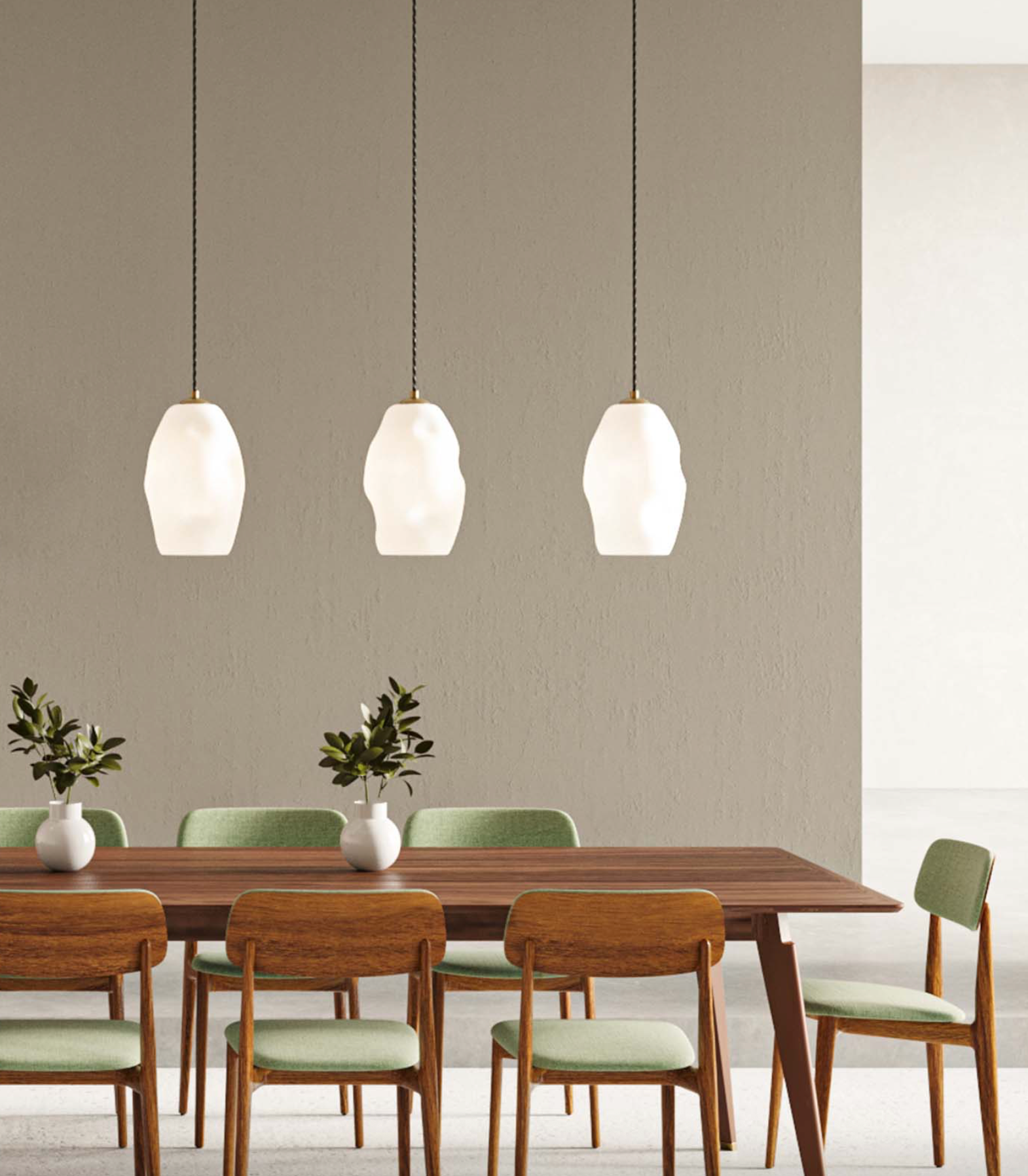 Dining room with wooden table and chairs, and three white glass pendant lights hanging above.